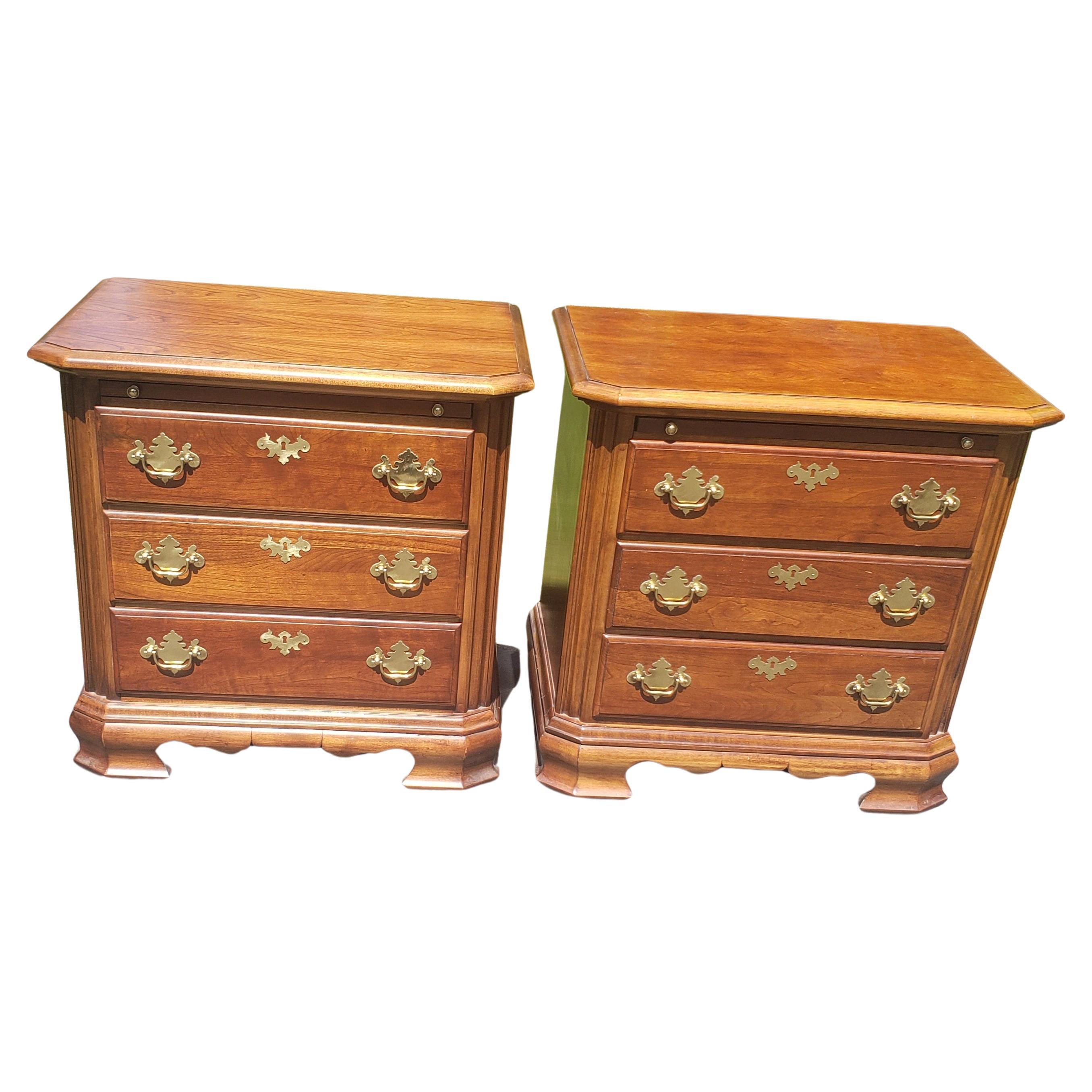 Beautifully crafted pair of Chippendale bedside tables from American Craftman Collection by Stanley Furniture. Solid cherry with brass handles. Pull out tray, smooth dovetailed drawers. Very good condition. Minor wear, appropriate with age and