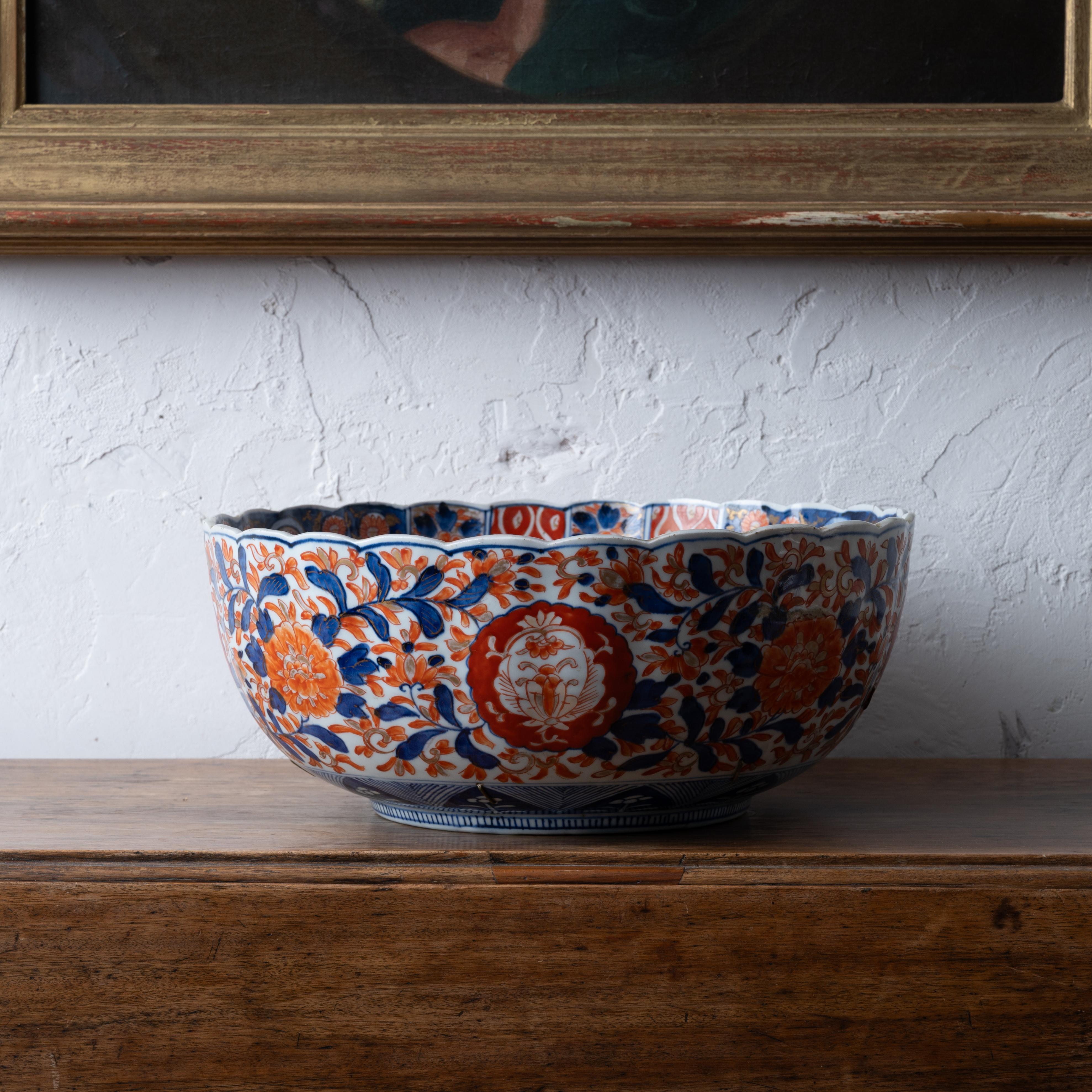A staple repaired Japanese Imari punch bowl, Meiji period, late 19th century.

14 ¾ inches wide by 6 ¼ inches tall