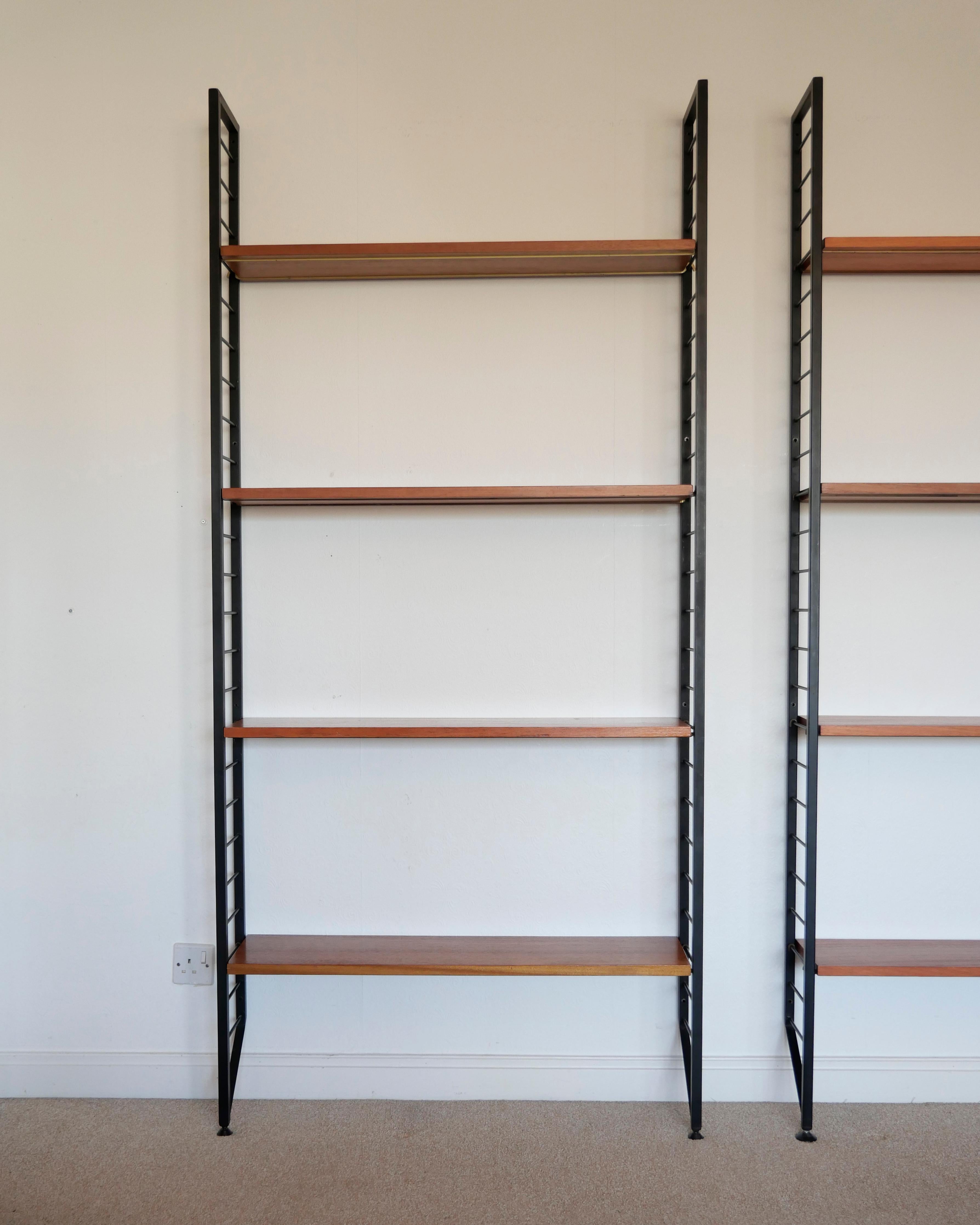 Robert Heal for Staples, 1964
'Ladderax' shelving system

[ NO. 1 of 2 UNITS AVAILABLE - THIS LISTING IS FOR THE LEFT HAND SIDE UNIT IN THE PHOTOS ]

One bay system. Four wooden shelves (each with two recessed metal supports), two metal 'ladder' 