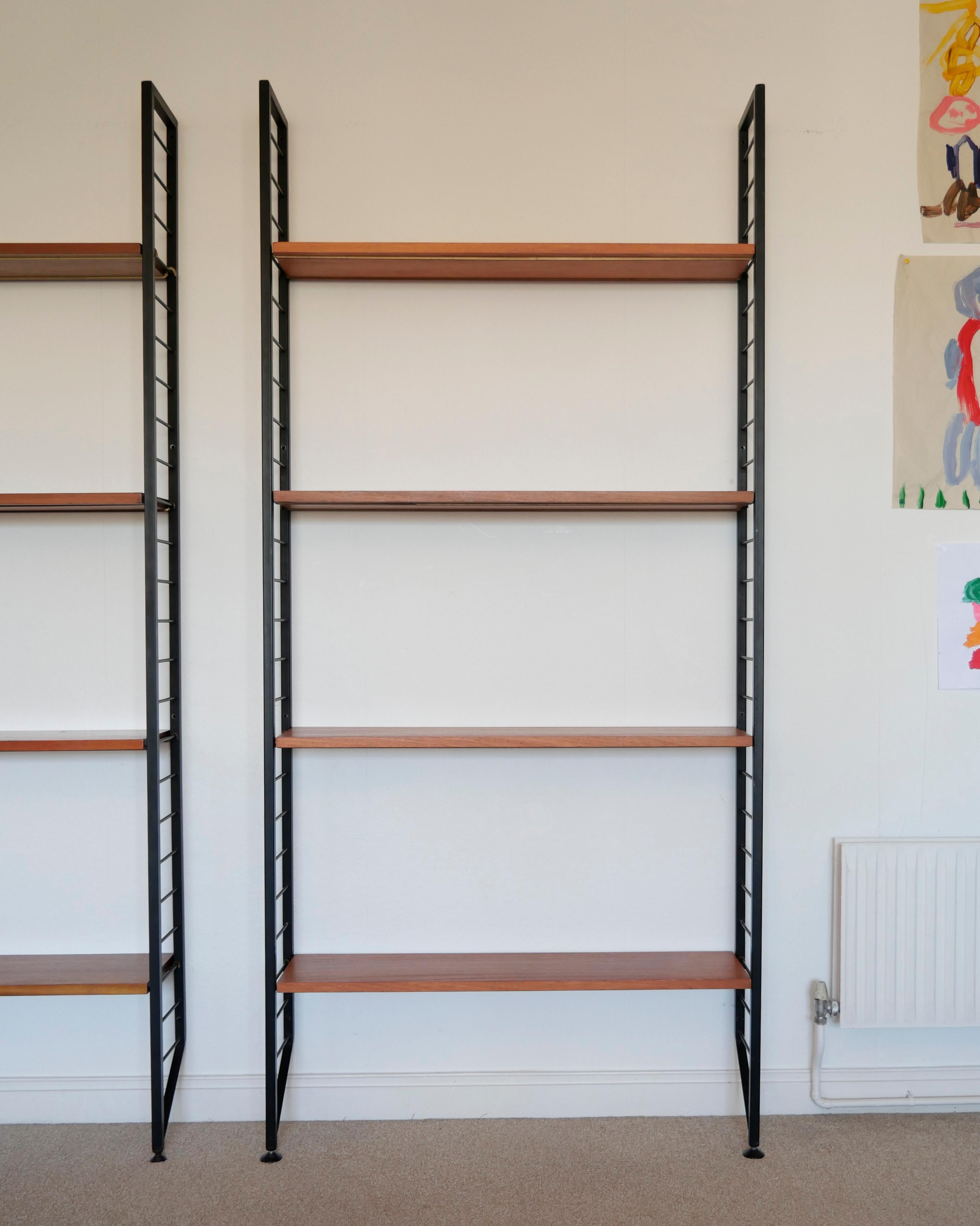 Robert Heal for Staples, 1964
'Ladderax' shelving system

[ NO. 2 of 2 UNITS AVAILABLE - THIS LISTING IS FOR THE RIGHT HAND SIDE UNIT IN THE PHOTOS ]

One bay system. Four wooden shelves (each with two recessed metal supports), two metal 'ladder' 