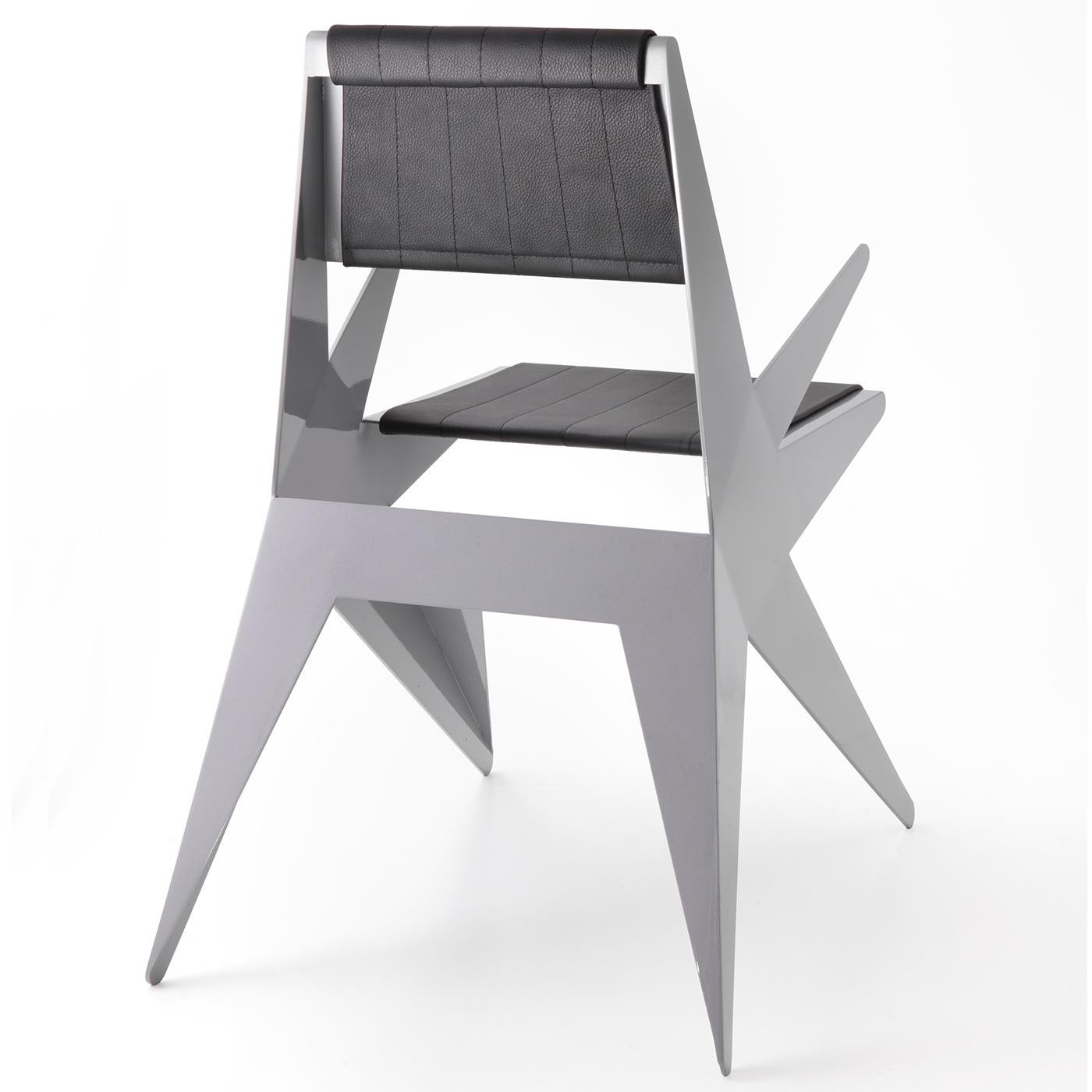 This unique chair with armrests is a design by Arch. Antonio Pio Saracino, inspired by the angular shape of a star. It is crafted by hand using an ultralight sheet of aluminum, artfully folded, welded, and finished by hand in lacquered black. The