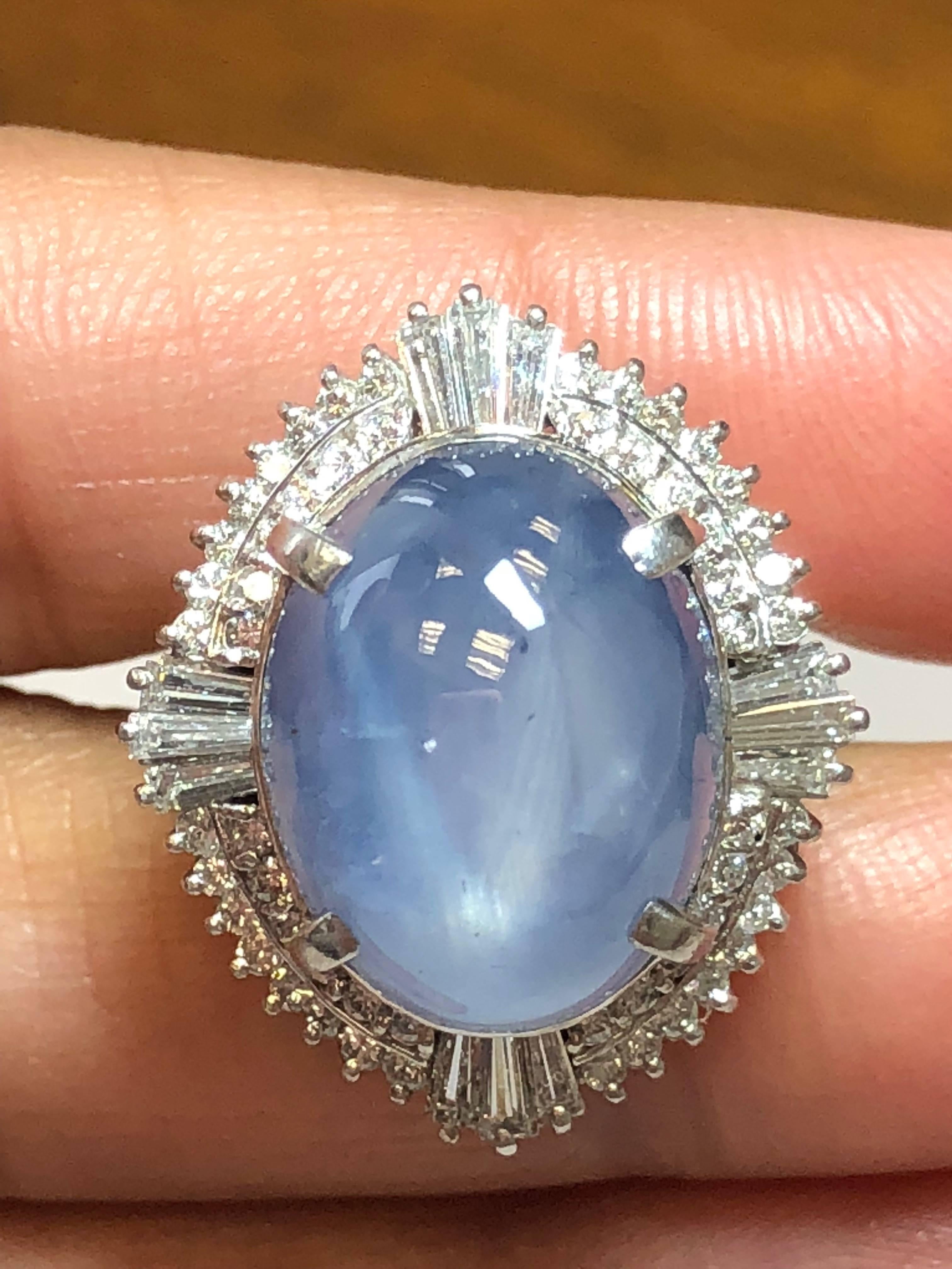 Gorgeous 26.12 carat of blue star sapphire cabochon surrounded by 1.21 carats of brilliant white diamonds in a platinum mounting size 5.5.  This cocktail ring showcases a dreamy blue color with a strong star.  A showstopper piece that is perfect for