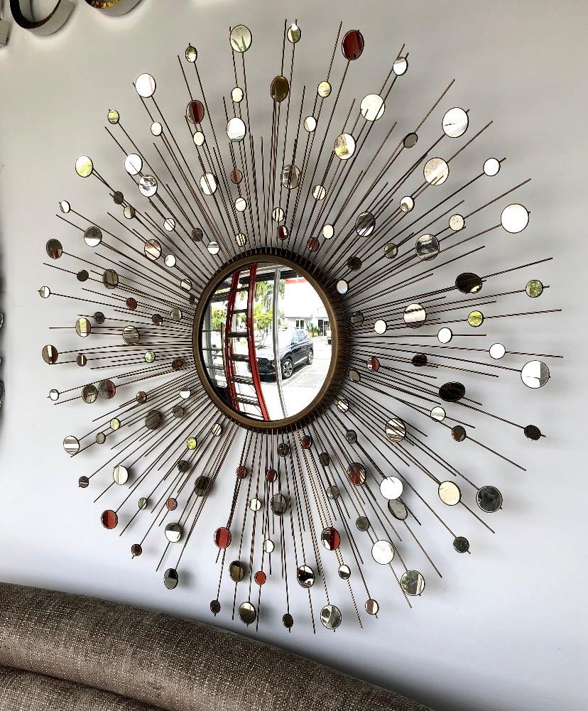 Spanning nearly 5 feet in diameter this stunning constellation mirror by Thomas Pheasant for Baker Furniture Company showcases brilliant craftsmanship. Each brass arm is individually applied and then fit with antiqued mirrored disks to create an