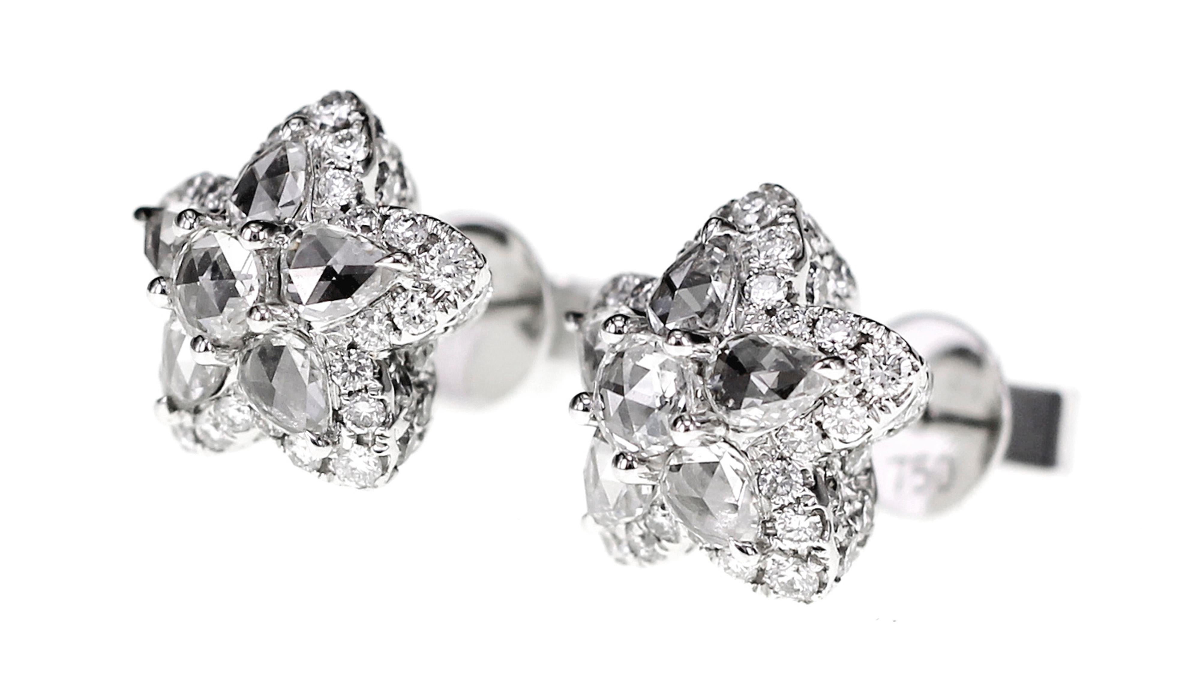 Soldered, sawed, carved, and shaped without the use of manufacturing machinery, this earring is a tough one to replicate. All made by hand, 3.10 carat of diamonds are set in this exclusive piece of jewelry. 