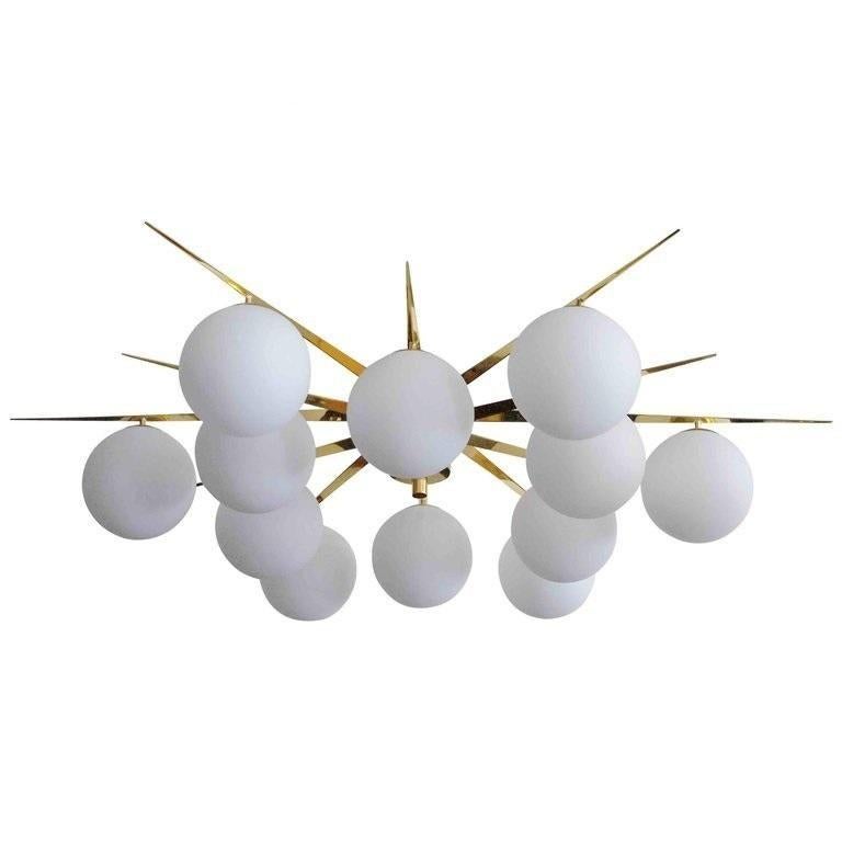 Italian flush mount with 12 large Murano glass globes mounted on brass frame / Made in Italy
Designed by Fabio Ltd, inspired by Angelo Lelli and Arredoluce styles
12 lights / E12 or E14 type / max 40W each
Diameter: 64 inches / Height: 14
