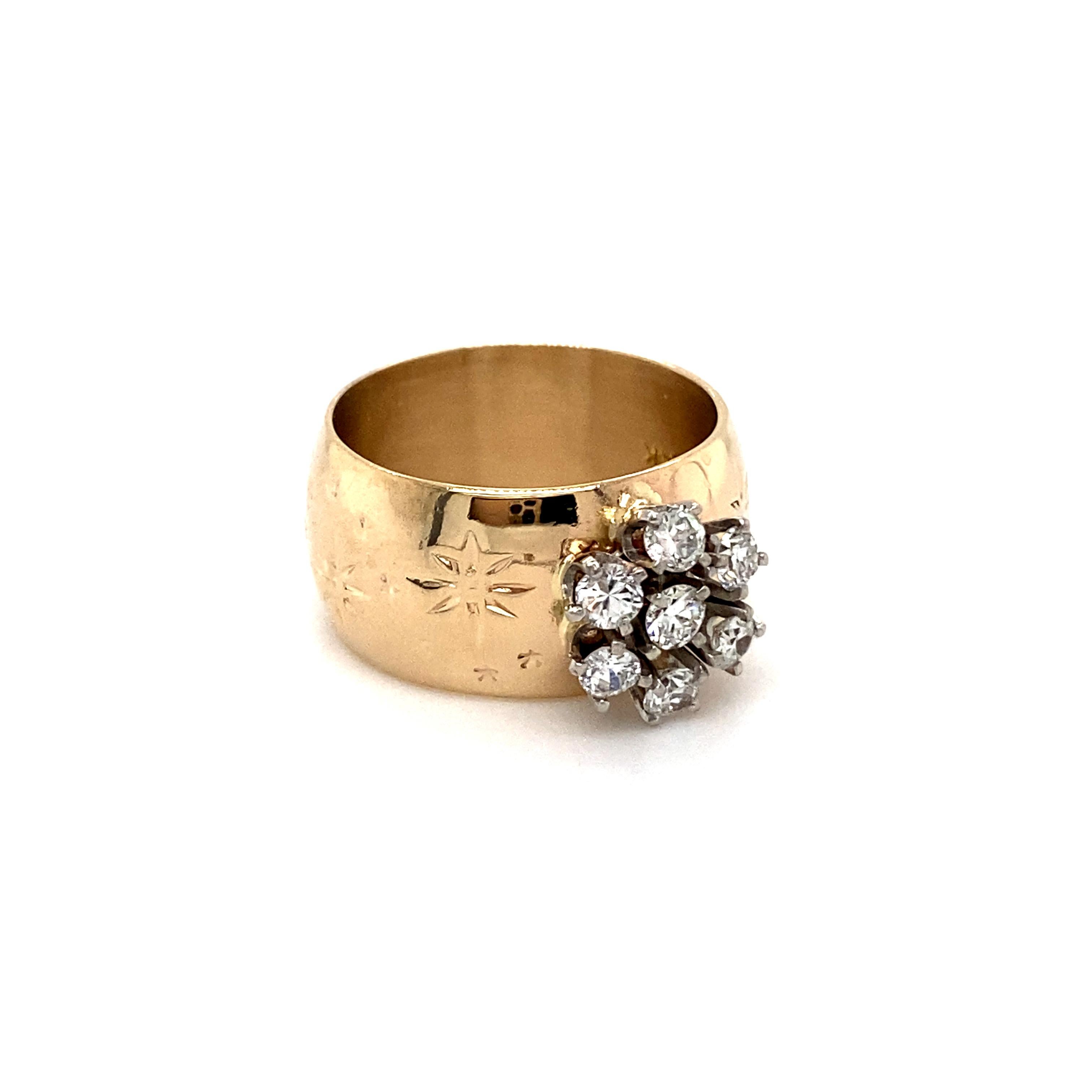This Wonderful Star Motif Wide Vintage Diamond Ring is uniquely beautiful. Crafted in 14K Yellow Gold, the band features a thick, wide band with an imprinted star motif in eternity, set with a lovely cluster of diamonds. In the center, the ring
