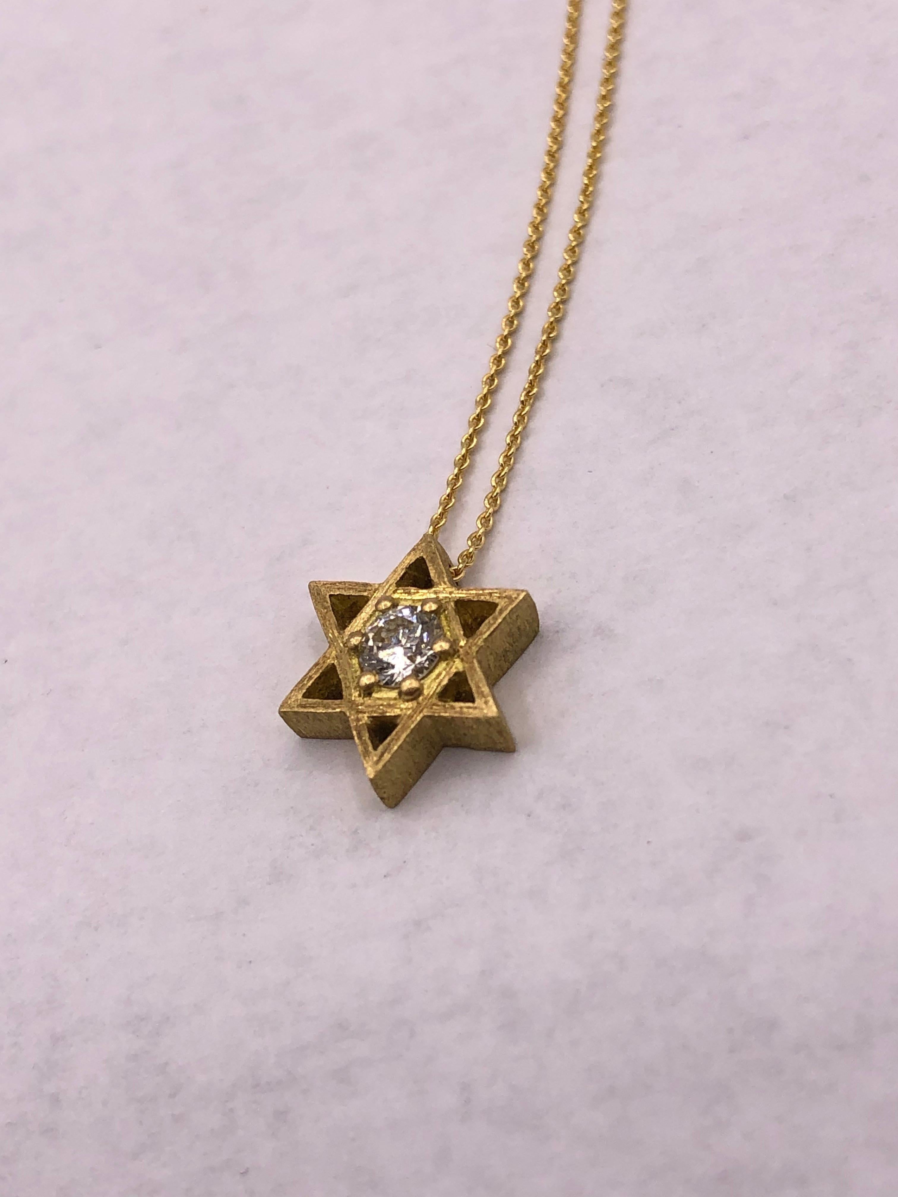 Beautiful dainty and yet weighty Star of David pendant necklace. A gorgeous 3.5mm white diamond center stone. Sits nicely below clavicle.

The Star of David was hand carved from wax and cast in 18k gold then hand etched to give a silky texture and