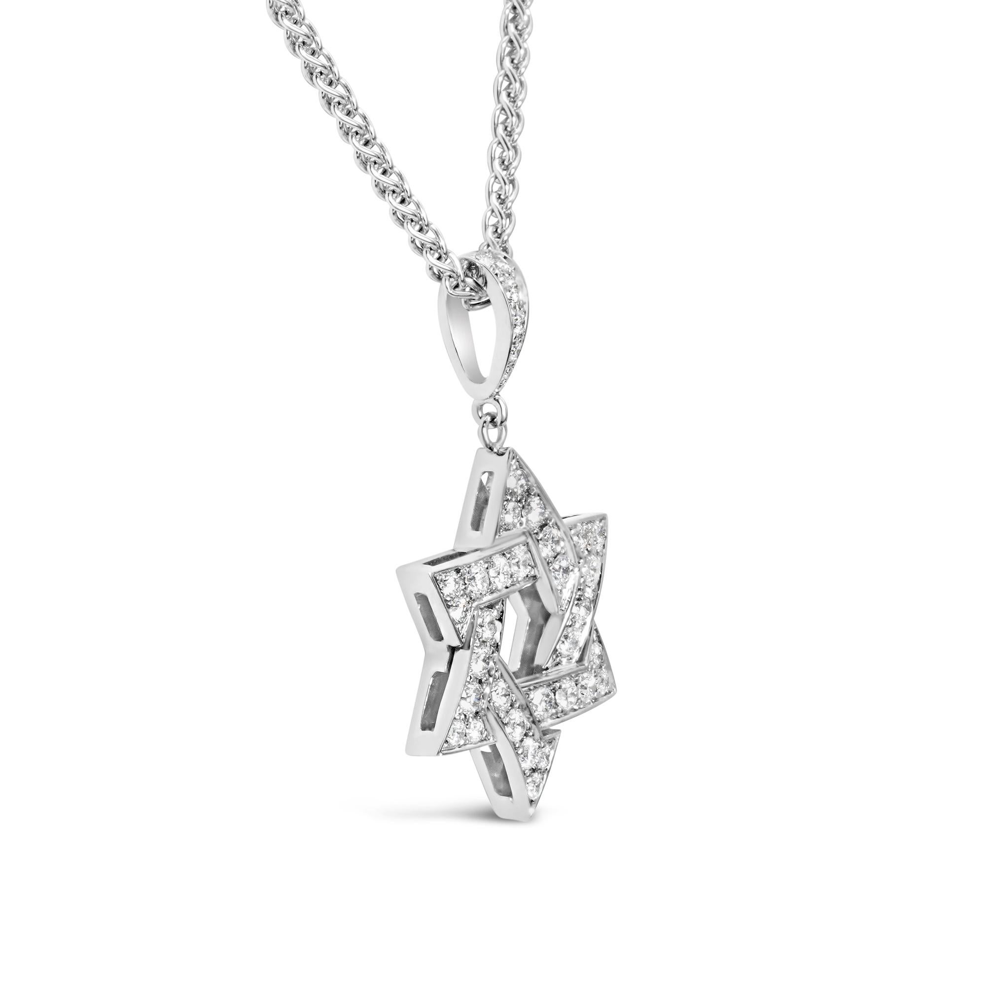 A wonderful religious necklace, featuring the Star of David accented by 0.60 carat total of round cut diamonds with F color and VS clarity. Finely made with 18K white gold. Suspended on a white gold chain, 18 inches in length. 

Roman Malakov is a