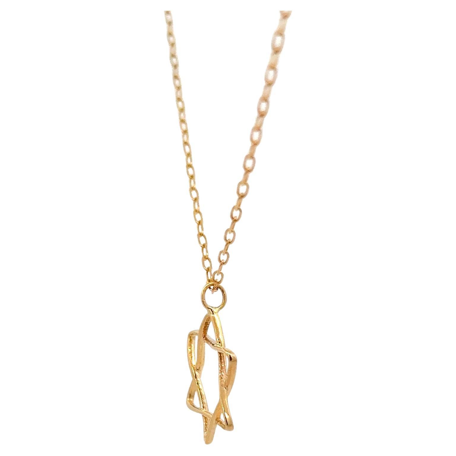 Star of David pendant featuring a 14 karat yellow gold wire motif on a cable chain.
