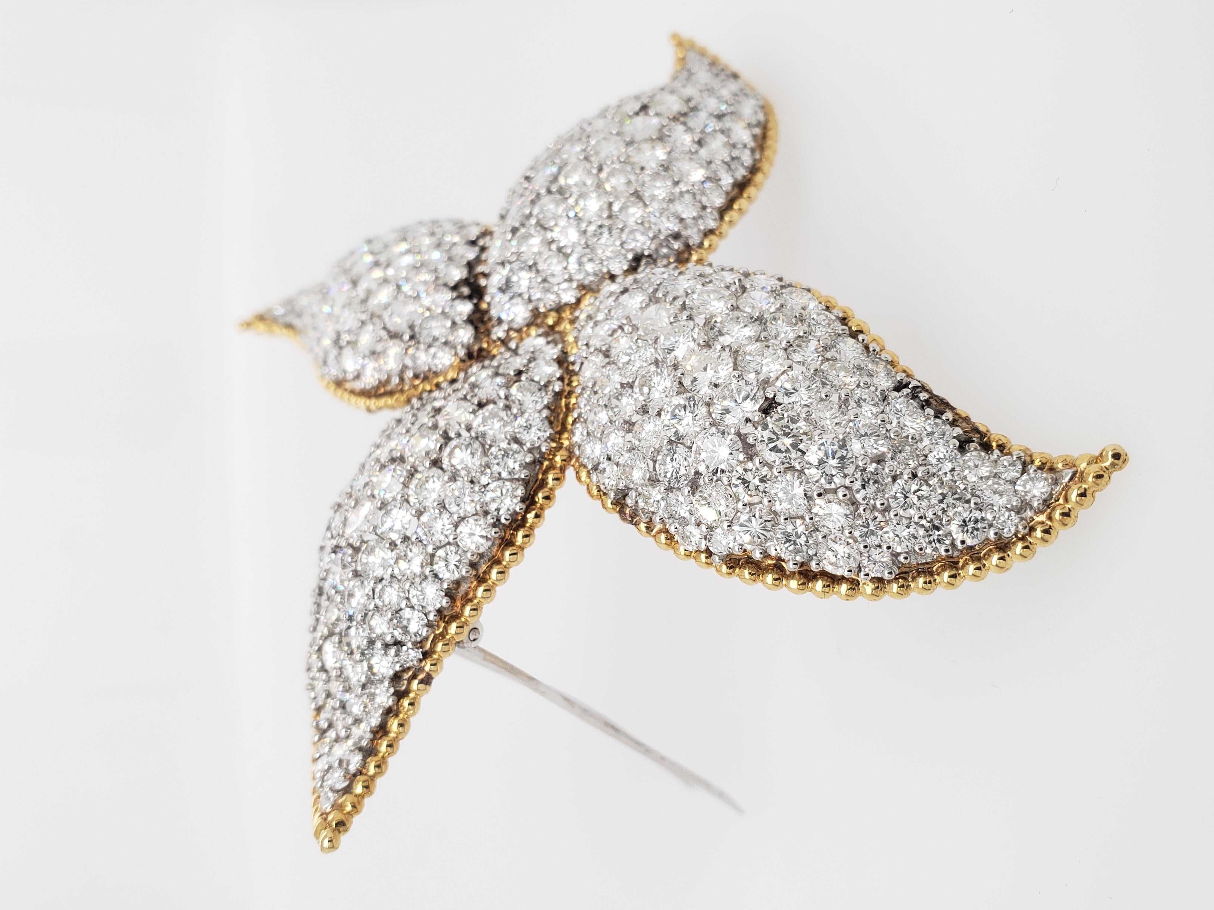 This one of a kind Brooch designed as a pinwheel is set with numerous round diamonds weighing approximately 34 Carats. Set within a Yellow Gold Frame.
The stone Setting is impeccable, giving off enormous luster! 

This 3 inch brooch will really make