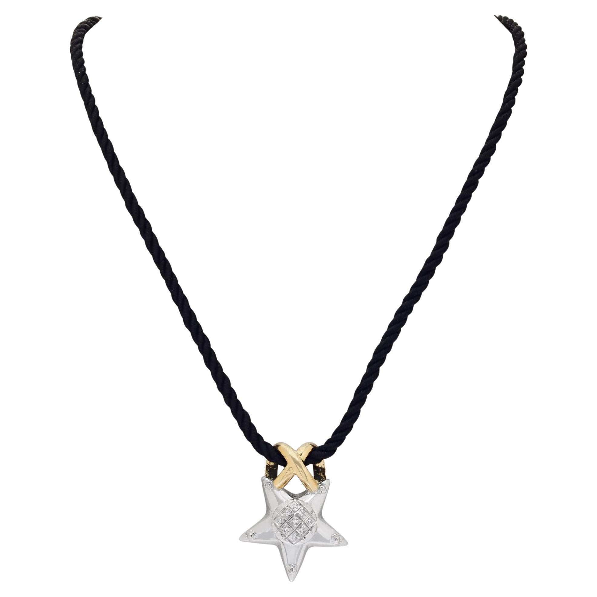 Star pendant with diamonds on a black breaded silk cord