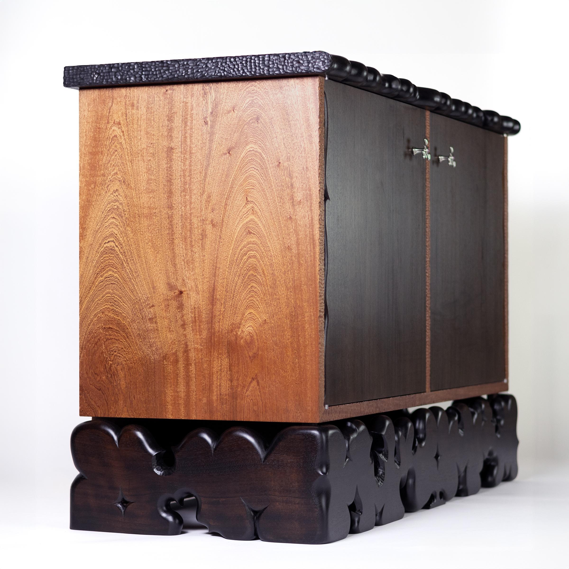 Inspired by ancient bas reliefs and petroglyphs, the Star Platinum Cabinet features intricate carvings and textural elements. The sinuous forms of the base feel like a mutated filigree, dancing around an altar for surreal rituals. Adorned with lost