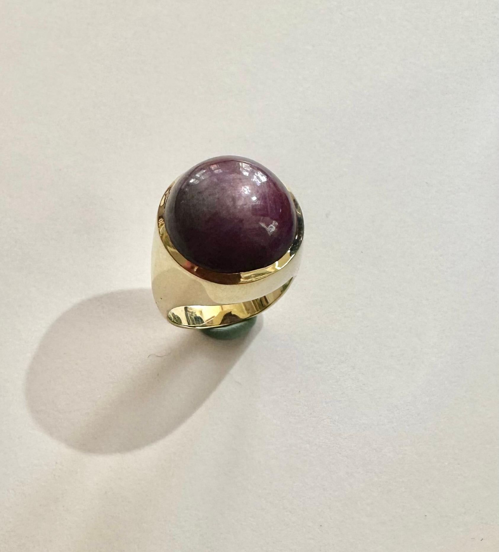 One (1) 12Karat Yellow Gold Ring.
Set with one Natural Corundum, STAR RUBY
Cabuchon (near round)
Measurments: 16.33 -16.79 x 13.84 mm   weight: ca. 40.88 Carart
Color: deep Purplish Red  Opaque , Asterism.
No indication of Heating
size of the ring: 