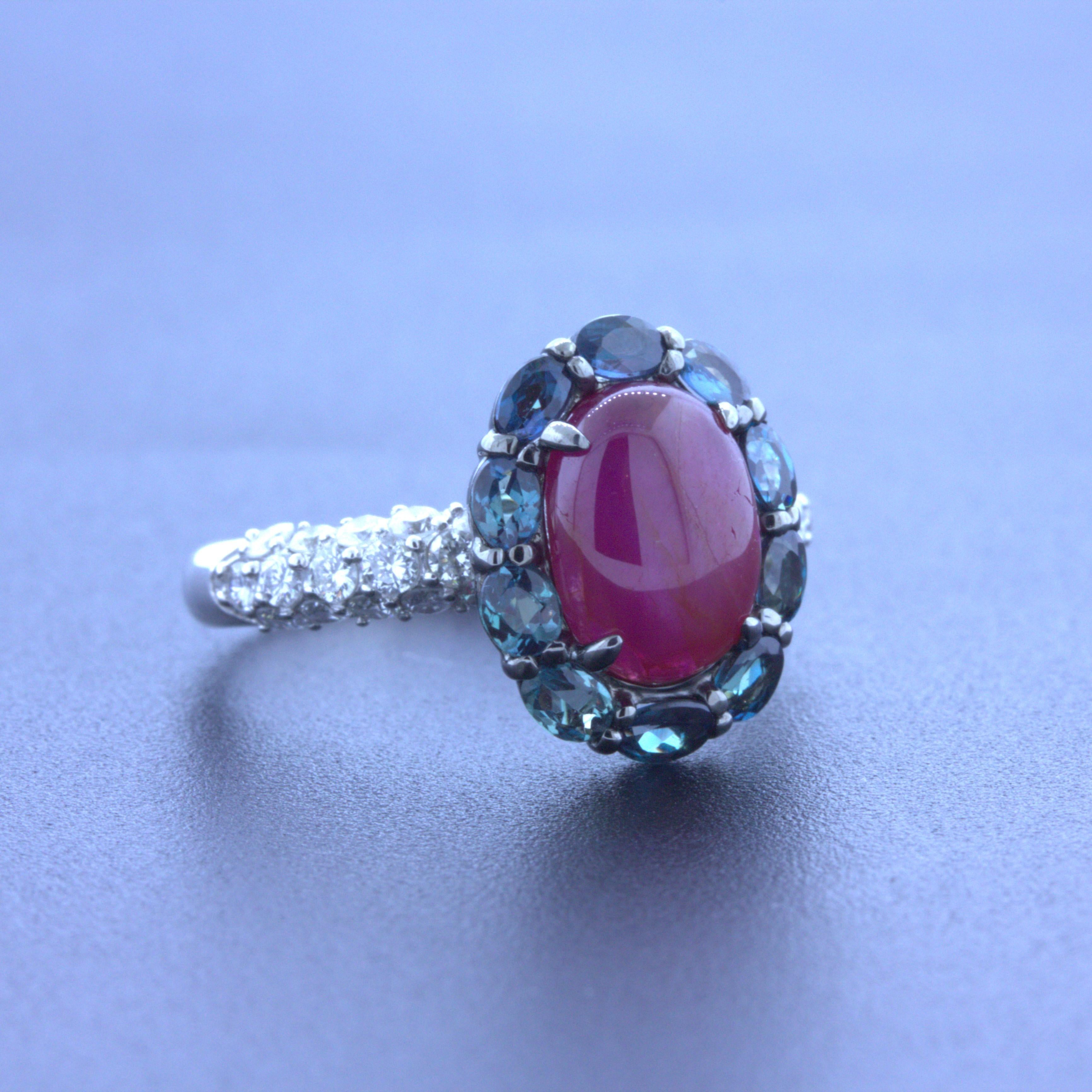 A stylish platinum ring featuring a star ruby surrounded by gem alexandrite and accented by bright white diamonds. The star ruby weighs 2.77 carats and has a rich vivid red color along with a strong 6-rayed star, asterism, when a light hits its top.