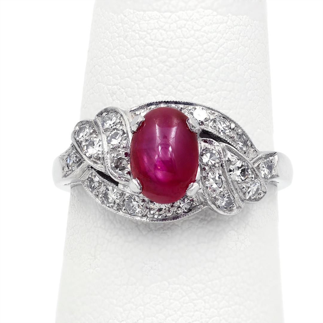 This 1950s platinum Art Deco ring features an oval cabochon star ruby weighing approximately 1.44 carats, and is accented with single cut diamonds weighing an approximate combined 0.44 carats with E-F coloring. The ring is a size 6.75 