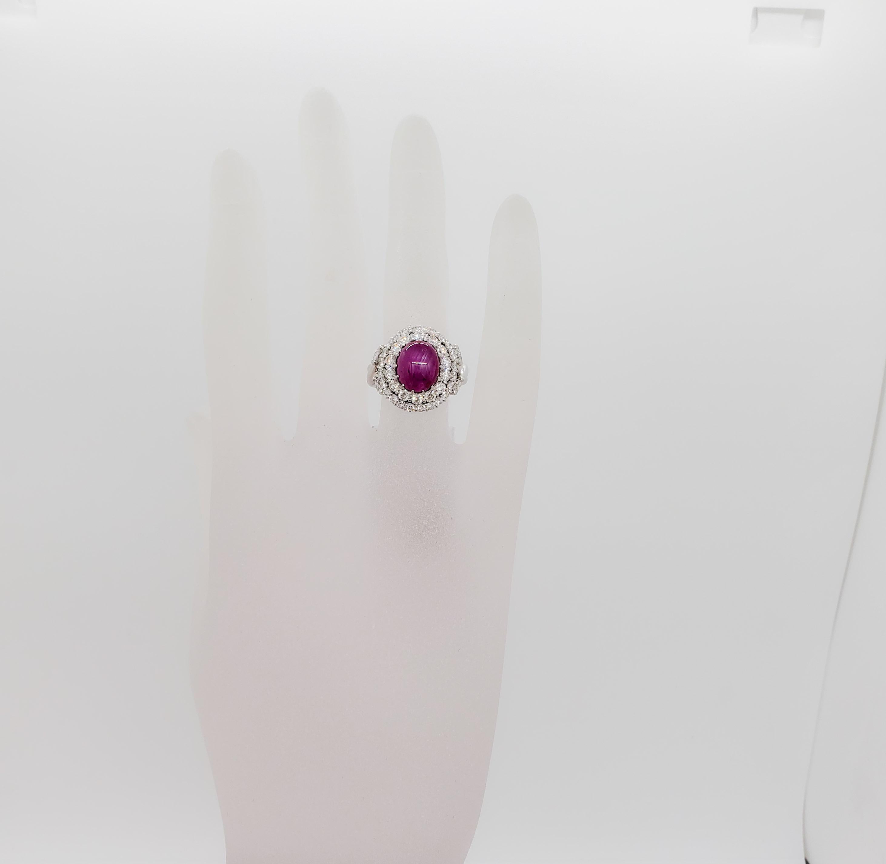 Gorgeous deep red 5.87 ct. star ruby cabochon oval with 1.57 ct. good quality white diamond rounds and marquise shapes.  Handmade platinum mounting in size 6.25.  