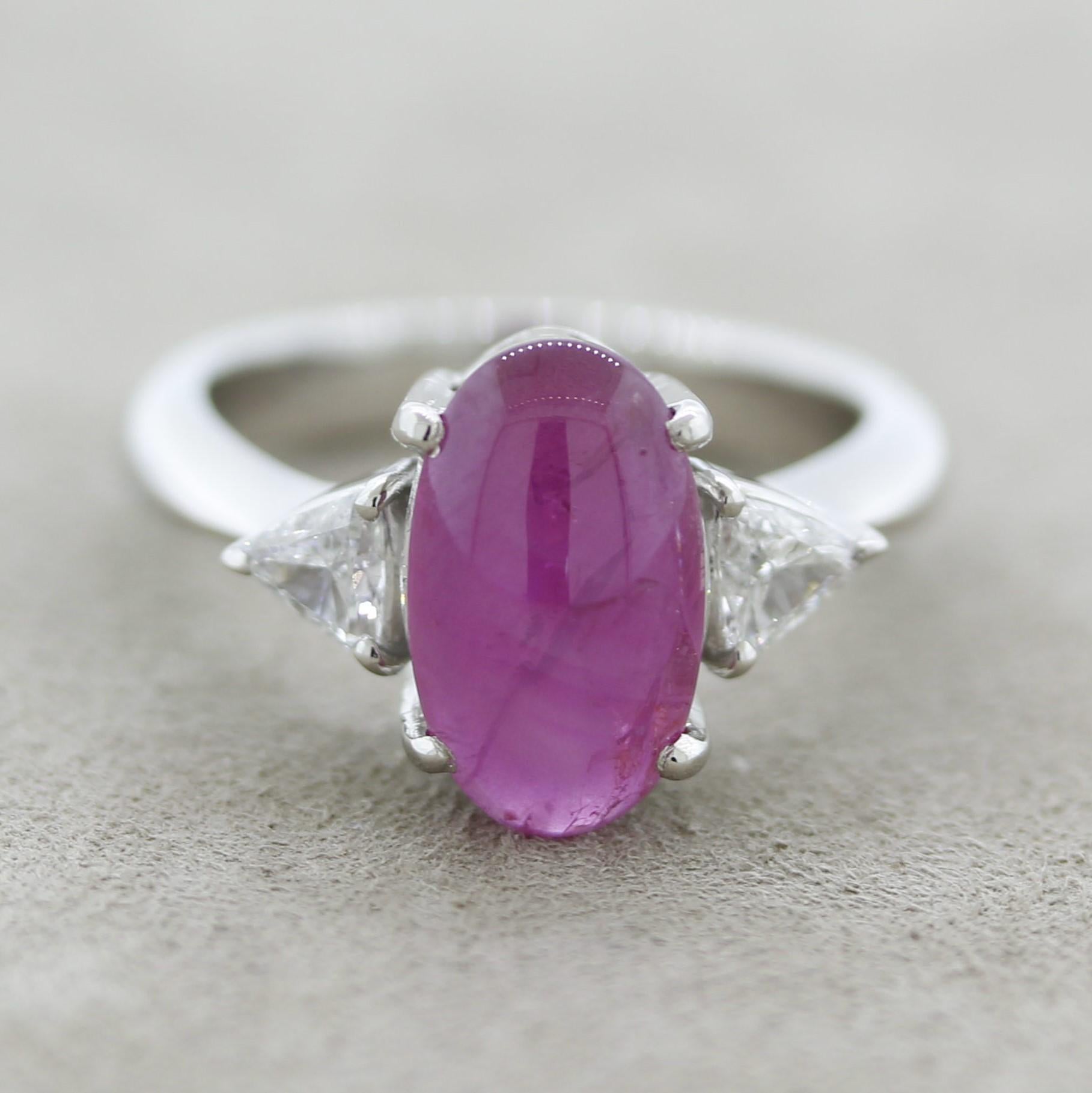 A lovely platinum ring featuring a 4.07 carat natural star ruby with no treatments of any kind. When a light is shined on it, or when the sunlight hits the stone, it shows a stone 6-ray star (asterism). It is complemented by two triangular-cut