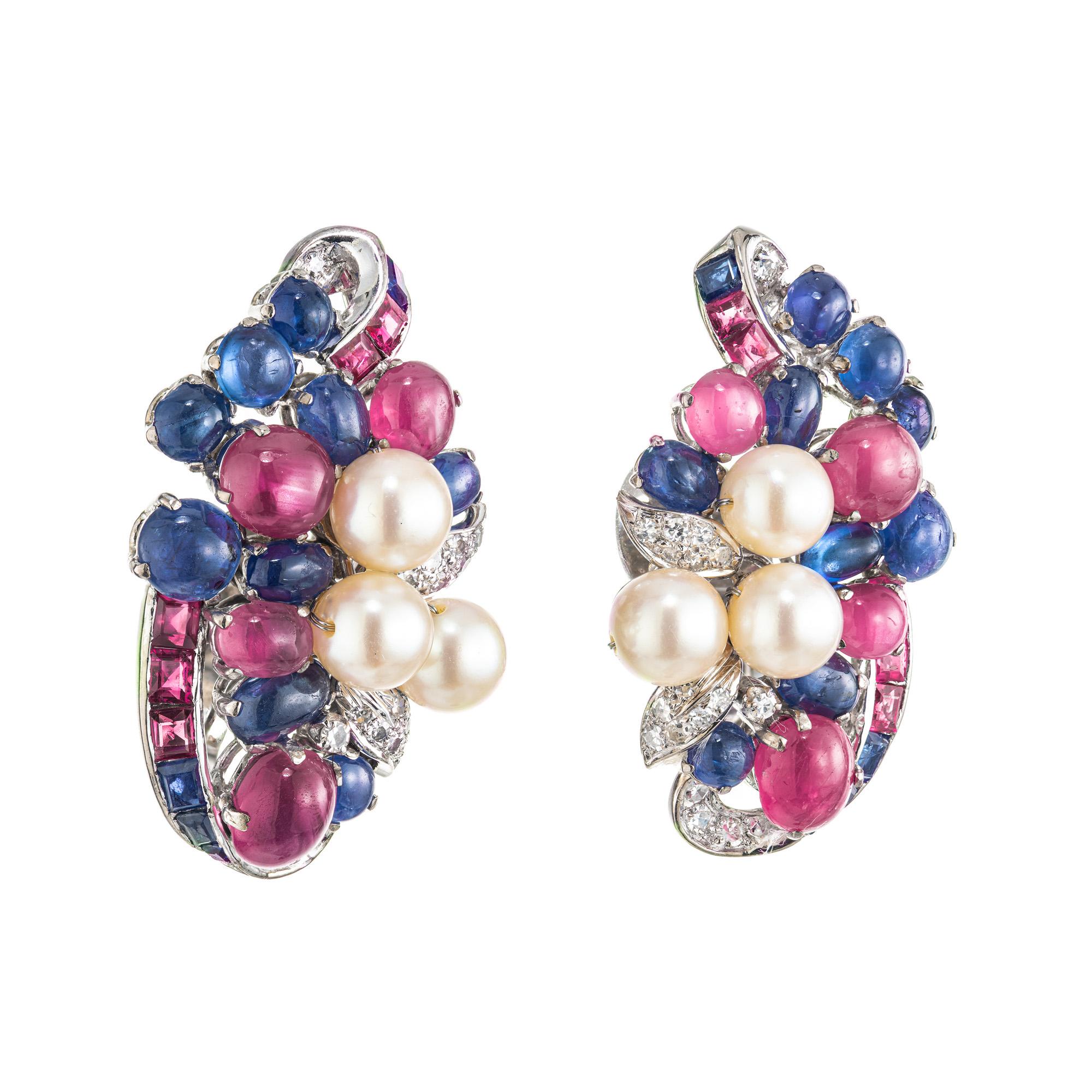 Wonderful large, yet secure clip post mid-century 1950's earrings in 14k white gold and set with 6.5 carats of natural star ruby and 4.80 carats of natural star sapphire with pearl and diamond accents. The pearls are undyed cultured Akoya pearls.