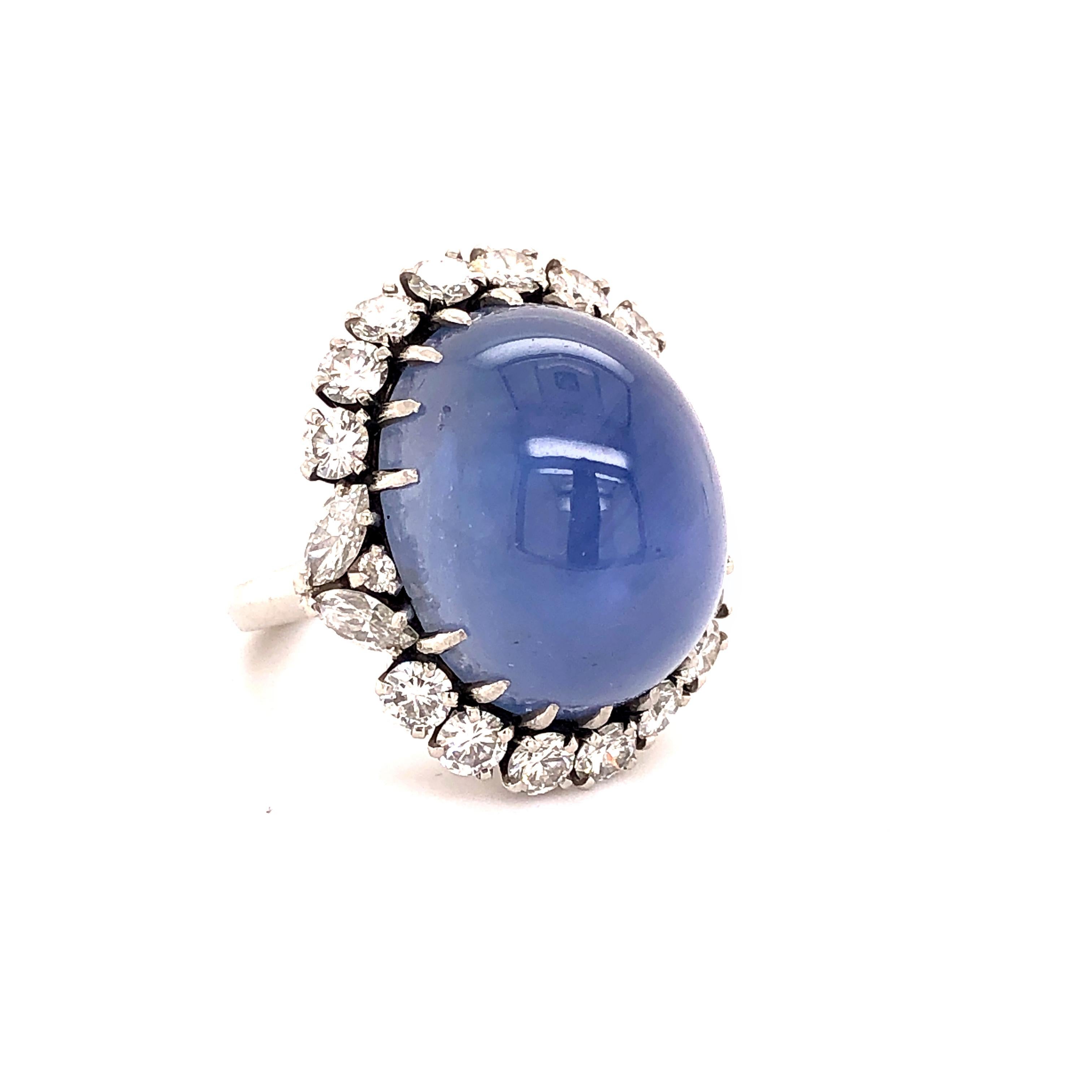 A stunning natural star sapphire and diamond ring. The sapphire is of Ceylon origin and weighs approximately 45 carats. The centre stone exhibits a sharp six ray star and is romantically surrounded by brilliant cut round and marquise diamonds,