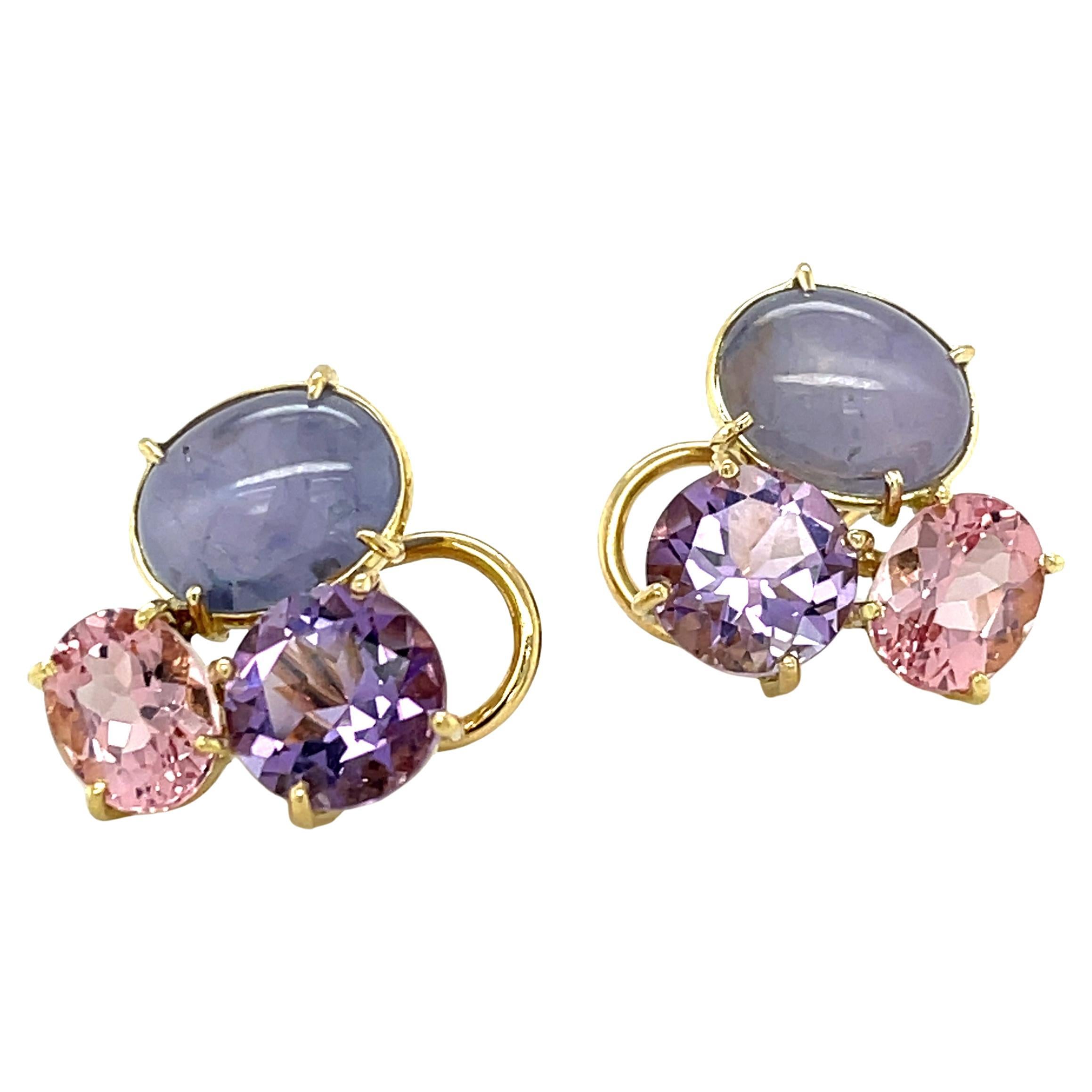 These one-of-a-kind  earrings feature an elegant and colorful combination of Rose de France amethyst, pink morganite, and lavender star sapphires set in 18k yellow gold. The Rose de France amethyst with its sparkling yet subtle purple hue pairs