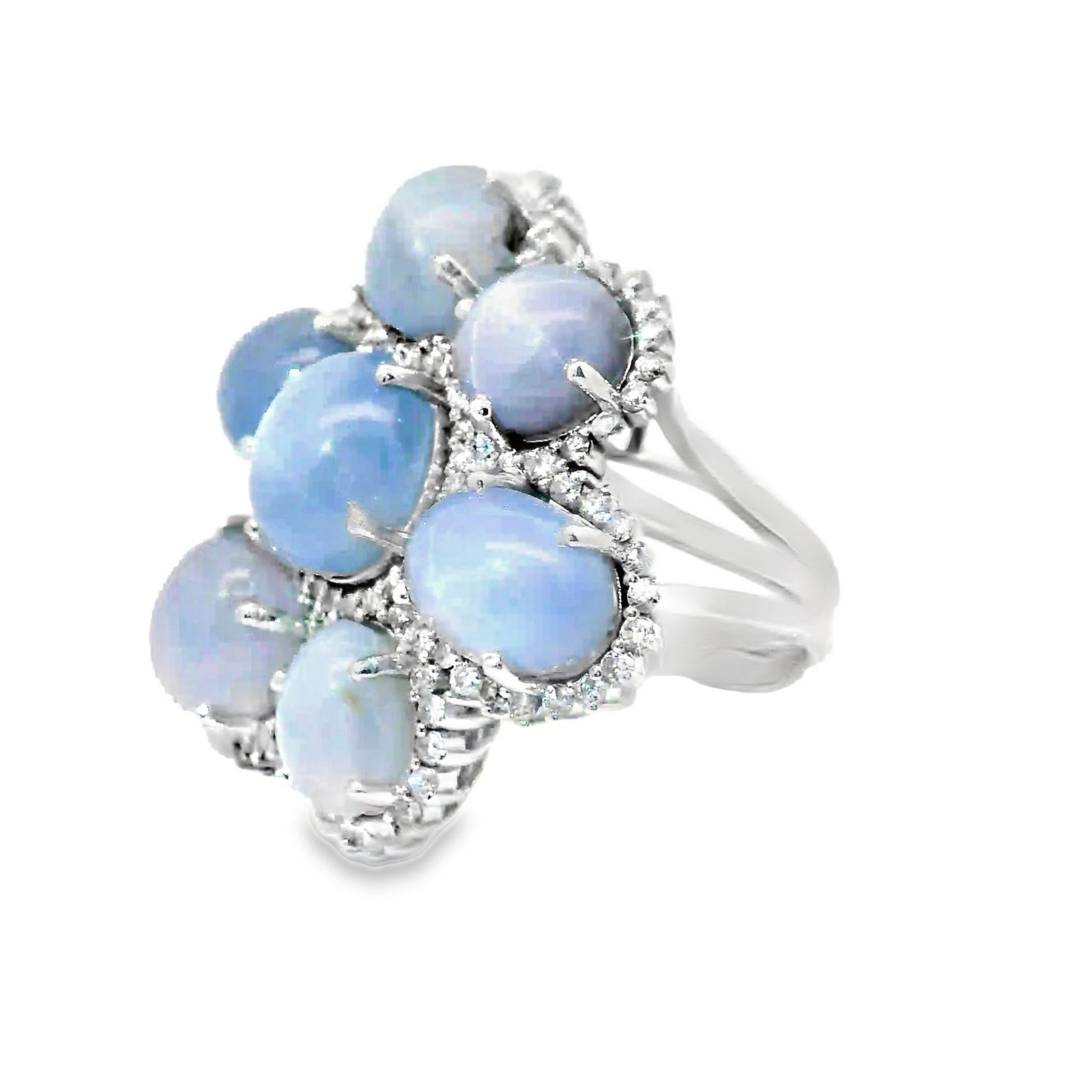 A striking cocktail ring featuring a 38.72 carats of blue star sapphire. There are a total of 7 star-sapphires, each with a sharp and distinct 6-rayed star. The sapphire's celestial glow is enhanced by 1.53 carats of round brilliant-cut white