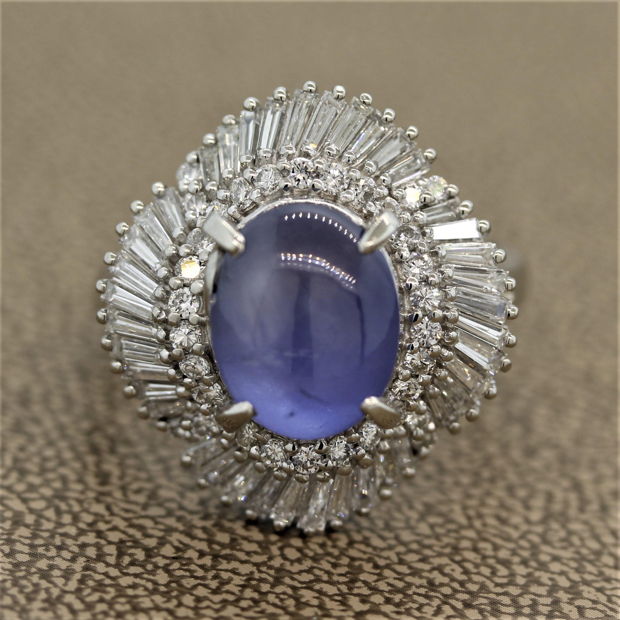 An elegant ring featuring a fine blue star sapphire weighing 9.71 carats. It is a pleasant blue color with a six-rayed star on its top when a light hits it. It is surrounded by 1.53 carats of round brilliant and baguette cut diamonds set in a