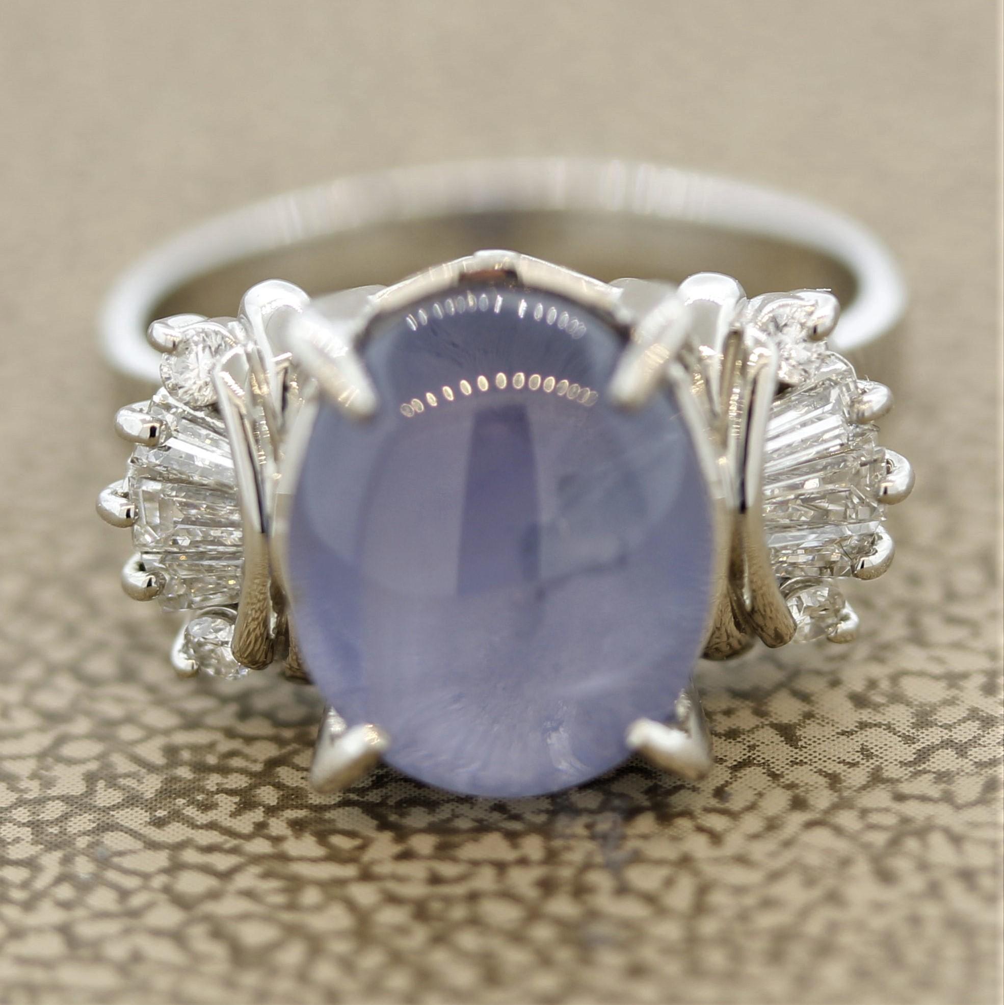 A lovely cabochon sapphire takes center stage. It weighs 7.90 carats and has fantastic asterism, which is the star effect when light hits the stone. A strong bright 6 rayed star can be seen on the sapphire. It is accented by 0.36 carats of round