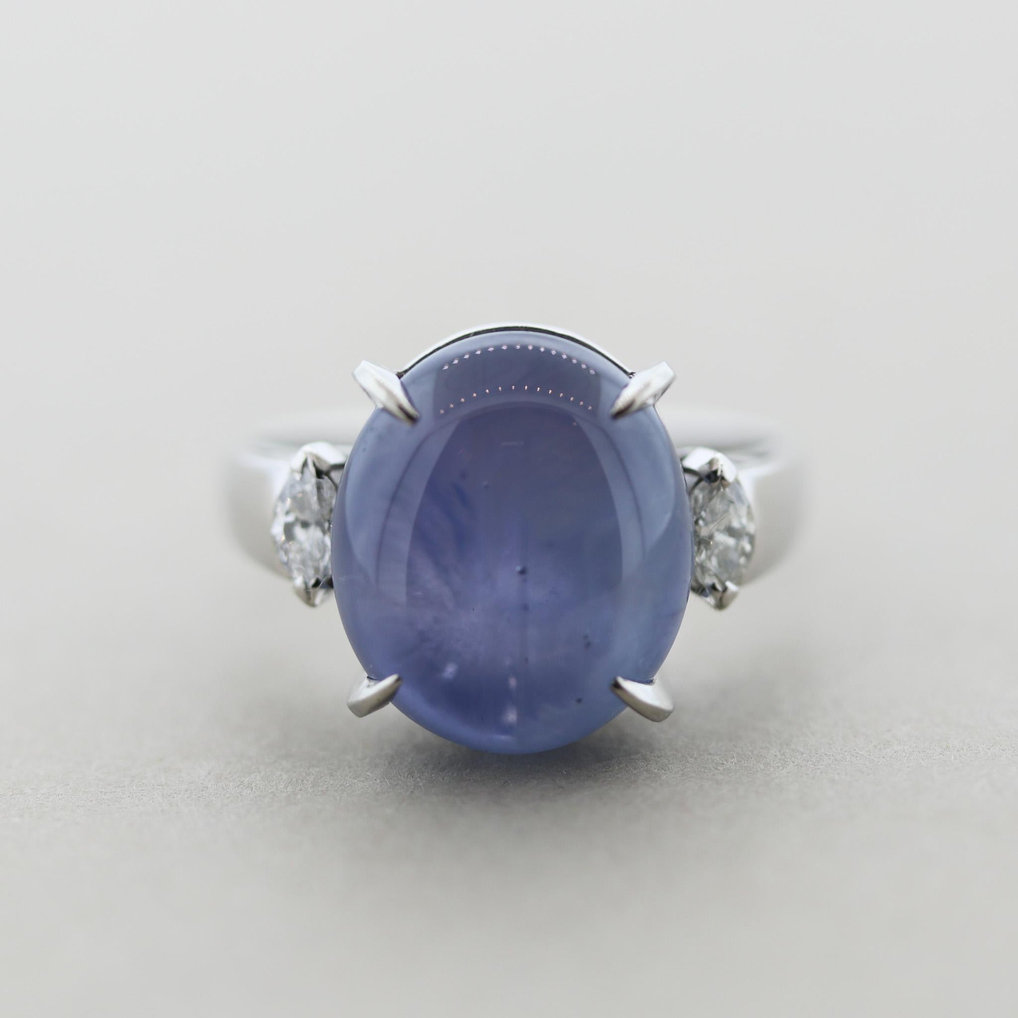 A simple and elegant ring featuring an 18.80 carat blue star sapphire with excellent asterism (6-ray star effect). It is complemented by 2 marquise shaped diamonds weighing 0.27 carats. Hand-fabricated in platinum and ready to be worn. The sapphire