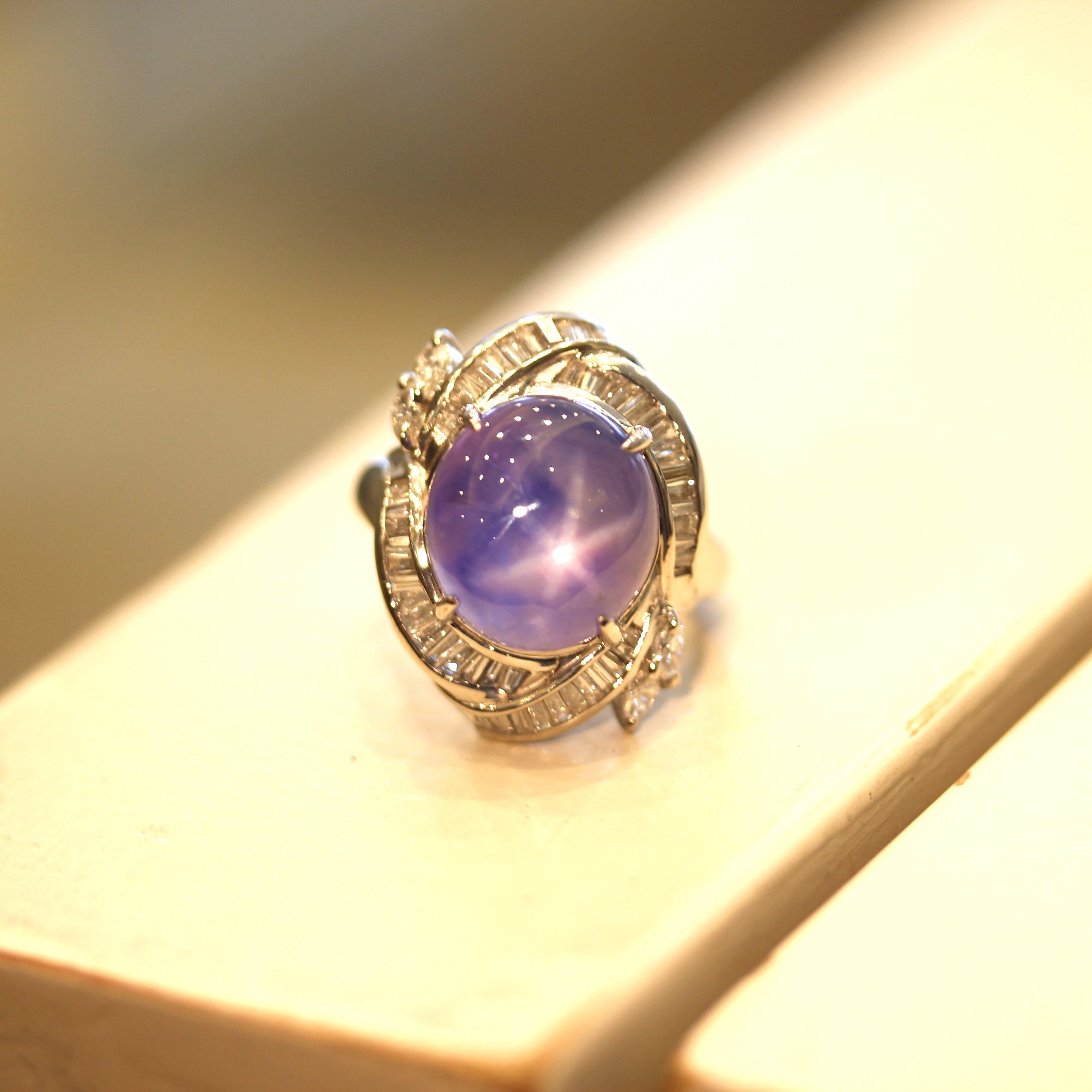 A large and impressive star sapphire weighing 15.81 carats which has a bright vivid purple-blue color and an excellent 6-rayed star. Adding to that, the sapphire is unheated and not treated in any way. It is complemented by 0.95 carats of diamonds