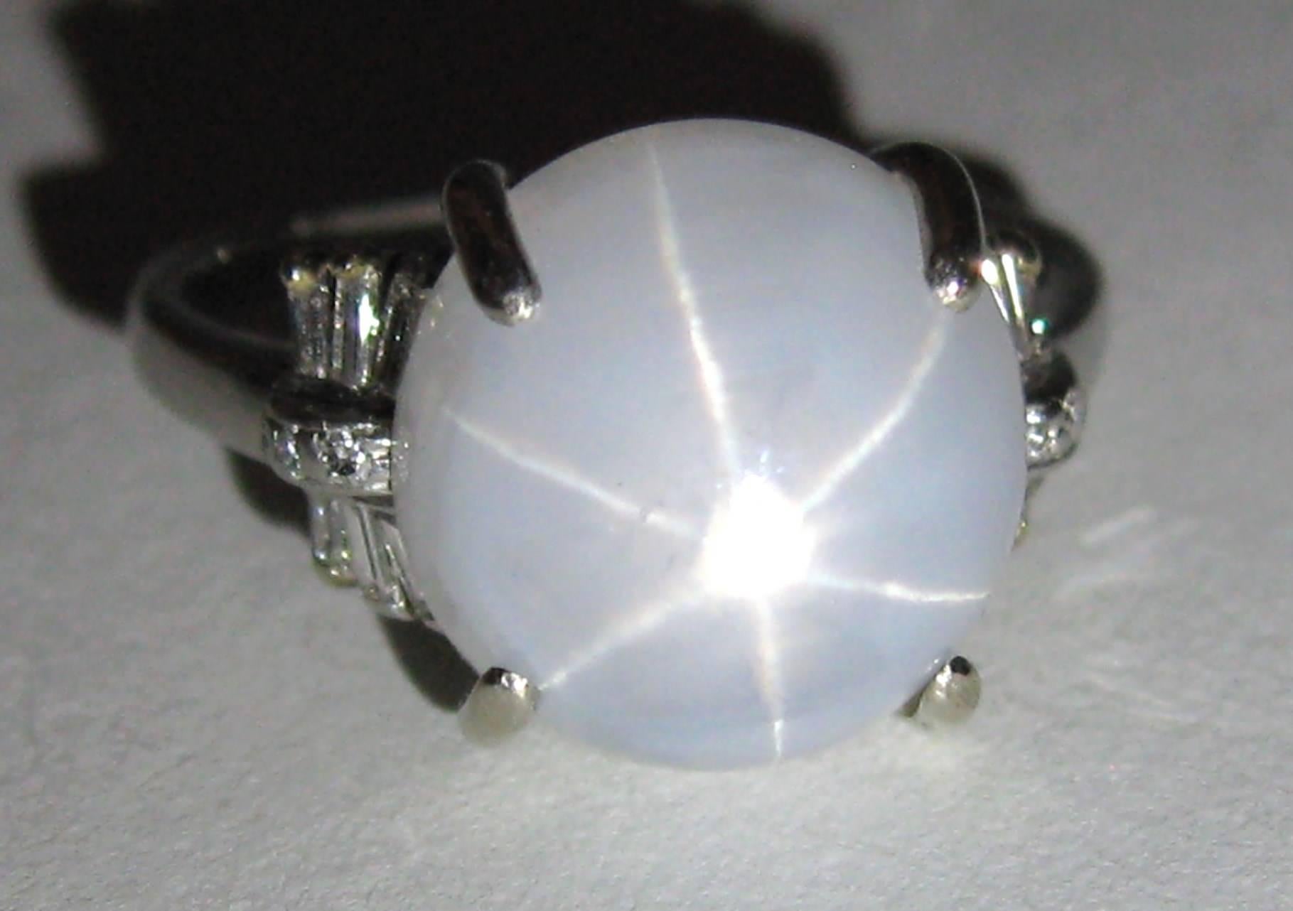 Early lovely platinum star sapphire cabochon Diamond ring, Carats, about 13 carats - Cut, Cabochon. Color, Light Blue, Baguette single cut diamonds flank both sides, Diamonds clarity VS-2 / SI-1. Size 5-3/8  but can be sized by us or your jeweler.