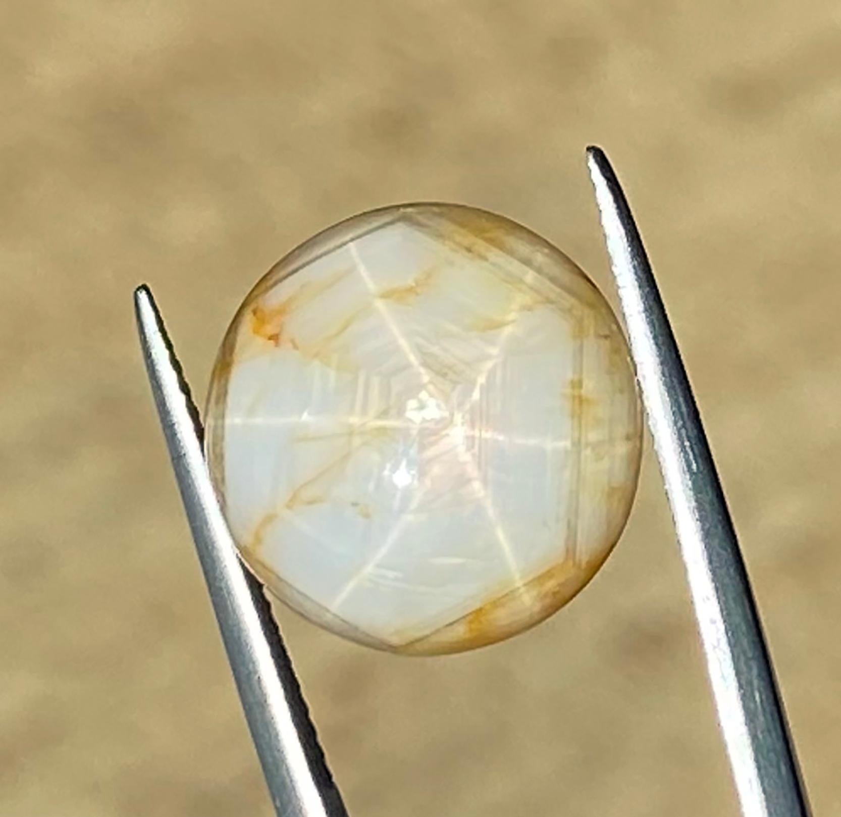Milk & Honey Star Sapphire from Sri Lanka. This cabochon star sapphire is completely natural in color with no treatment or enhancement.
Asterism in gemstones refers to a phenomenon where a star-like pattern appears on the surface of a gemstone when