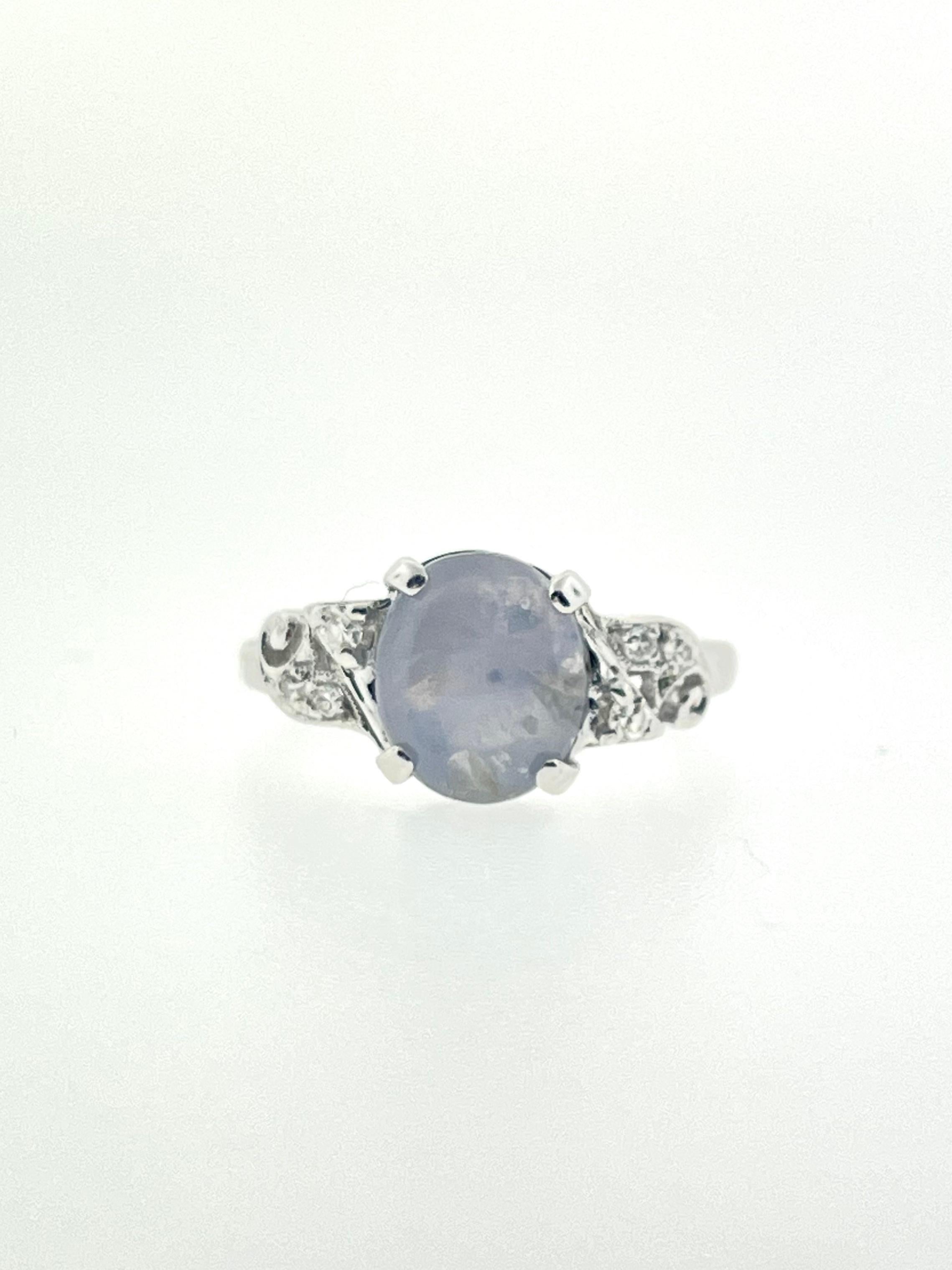 A beautiful star sapphire straight from the ground! This bright star sapphire is surrounded by three round diamonds on each side all set in white gold, this one is for you! 

*center stone has slight inclusion on the side* 