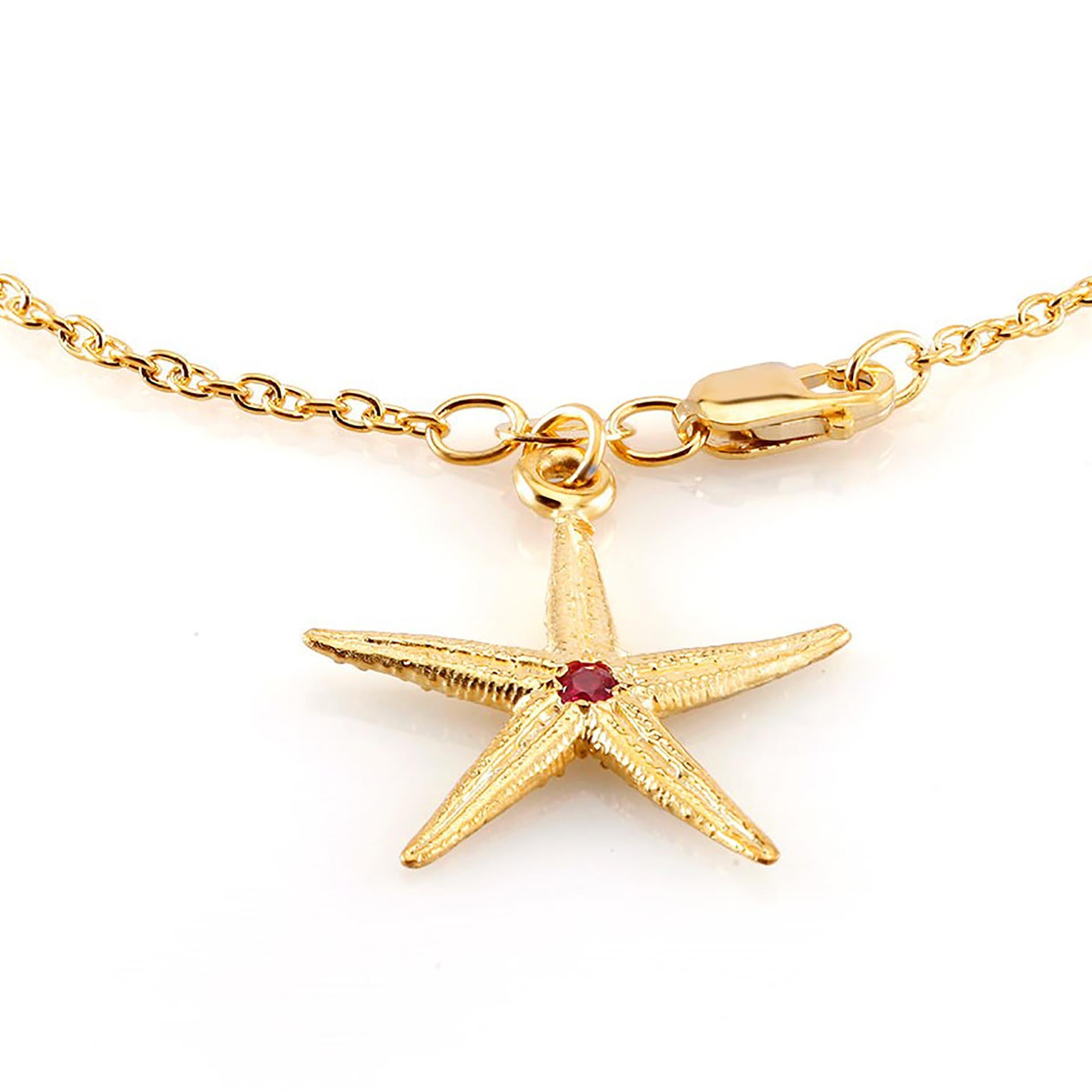Sterling Silver link bracelet 
Star shape charm measuring one inch
Lobster claw clasp
One ruby weight 0.10 carat 
Bracelet seven inch long 
New bracelet
Yellow gold plated 
