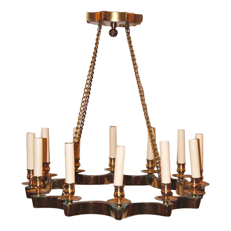 A set of 3 Moderne style star-shaped light fixture with gilt finish. 12 lights. Original chain and canopy.
We have 2 sizes of this fixtures, 21