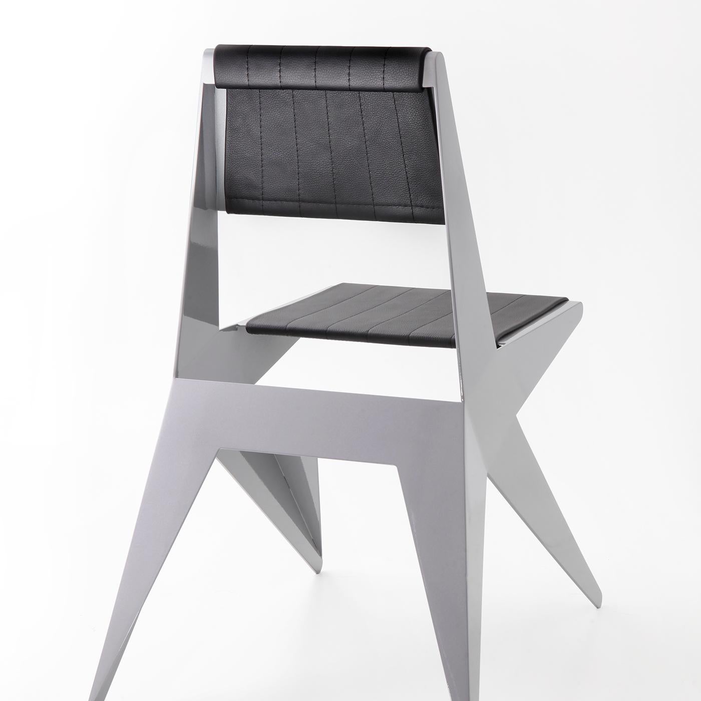 An eye-catching addition to both indoor and outdoor, this unique chair is handcrafted of a thin aluminum sheet, welded by hand and finished in a clear glossy coating. The pointy legs, squared back, and seat (H 47 cm) radiate from the centre creating