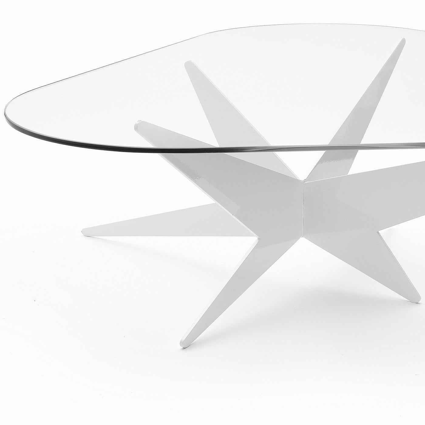 Inspired by the timeless elegance of the stars, this coffee table designed by Antonio Pio Saracino features a satin-finished aluminum base holding a triangular glass tabletop. The three-dimensional, starburst shape boasts eight rays radiating from