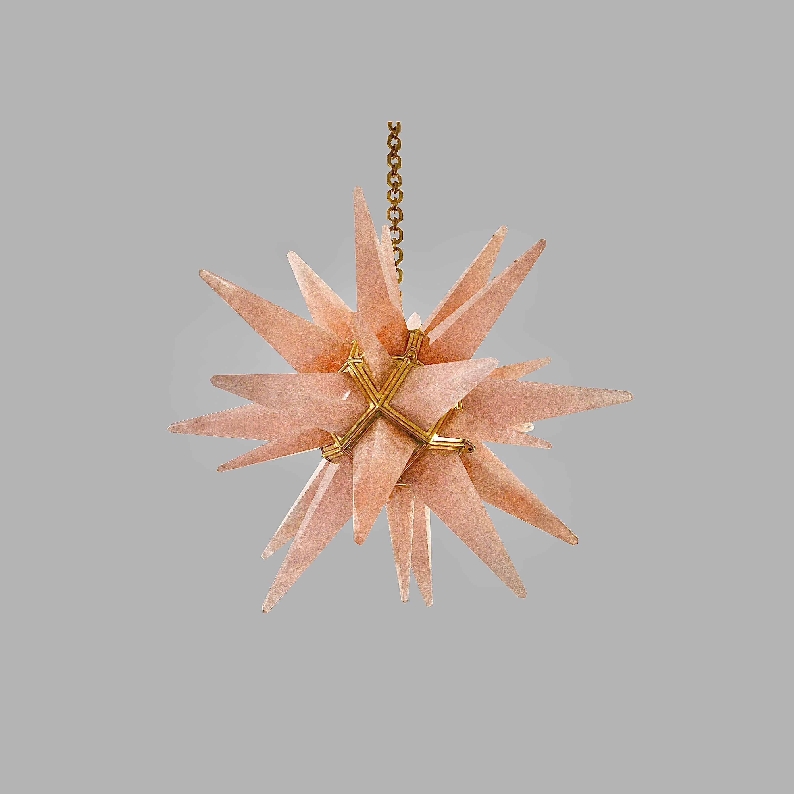 Pink rock crystal star chandelier with polish brass frame,Created by Phoenix Gallery, NYC.
Two candlelabra socket installed. Use two 75 watts LED candelabra lightbulbs.

Light bulb supplied.

Custom size and metal finish upon request.