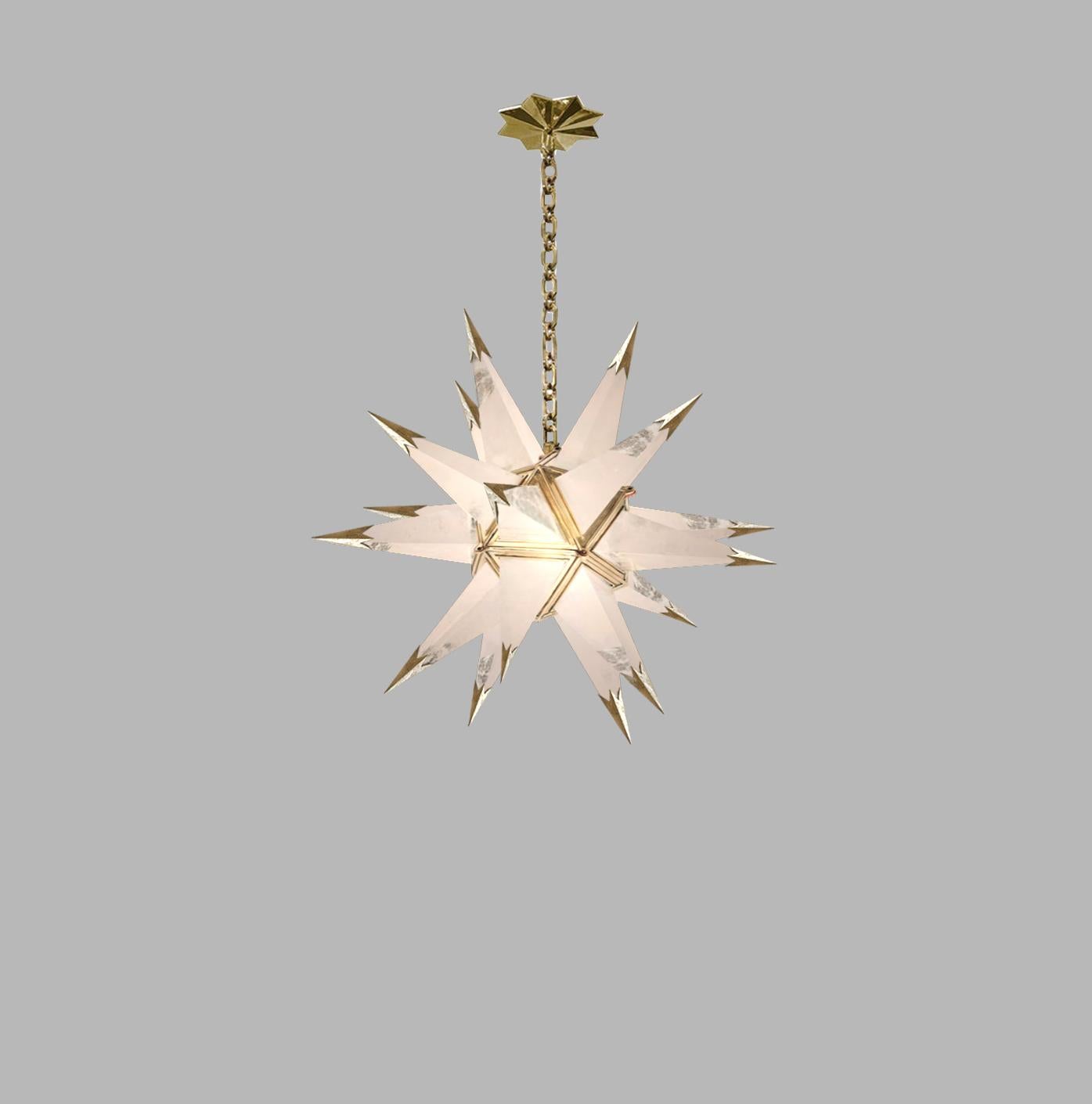 Finely carved star form rock crystal chandelier with polished brass finish frame. Created by Phoenix Gallery, NYC.
The chandelier is 21.5