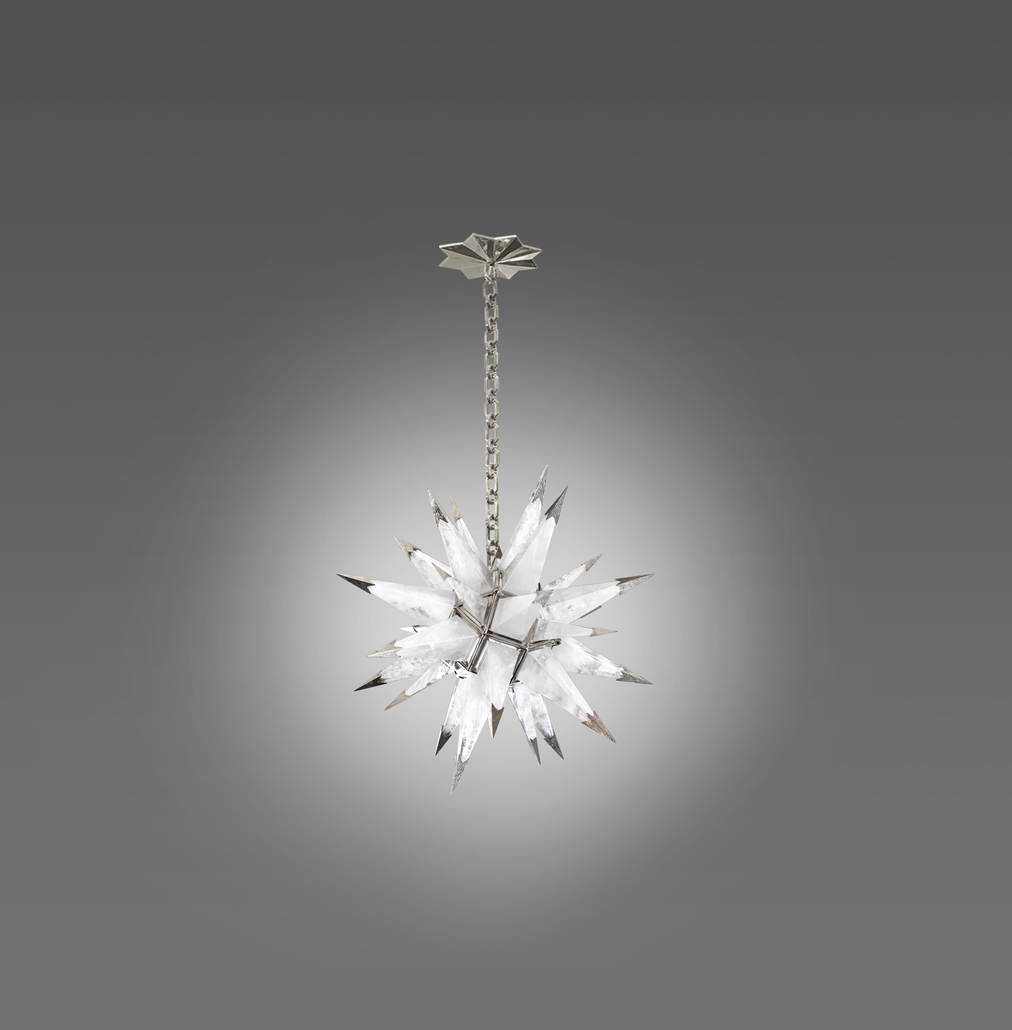 A finely carved star form rock crystal chandelier with nickel plating finishes frame and tips. Created by Phoenix Gallery, NYC.
The chandelier is 21.5
