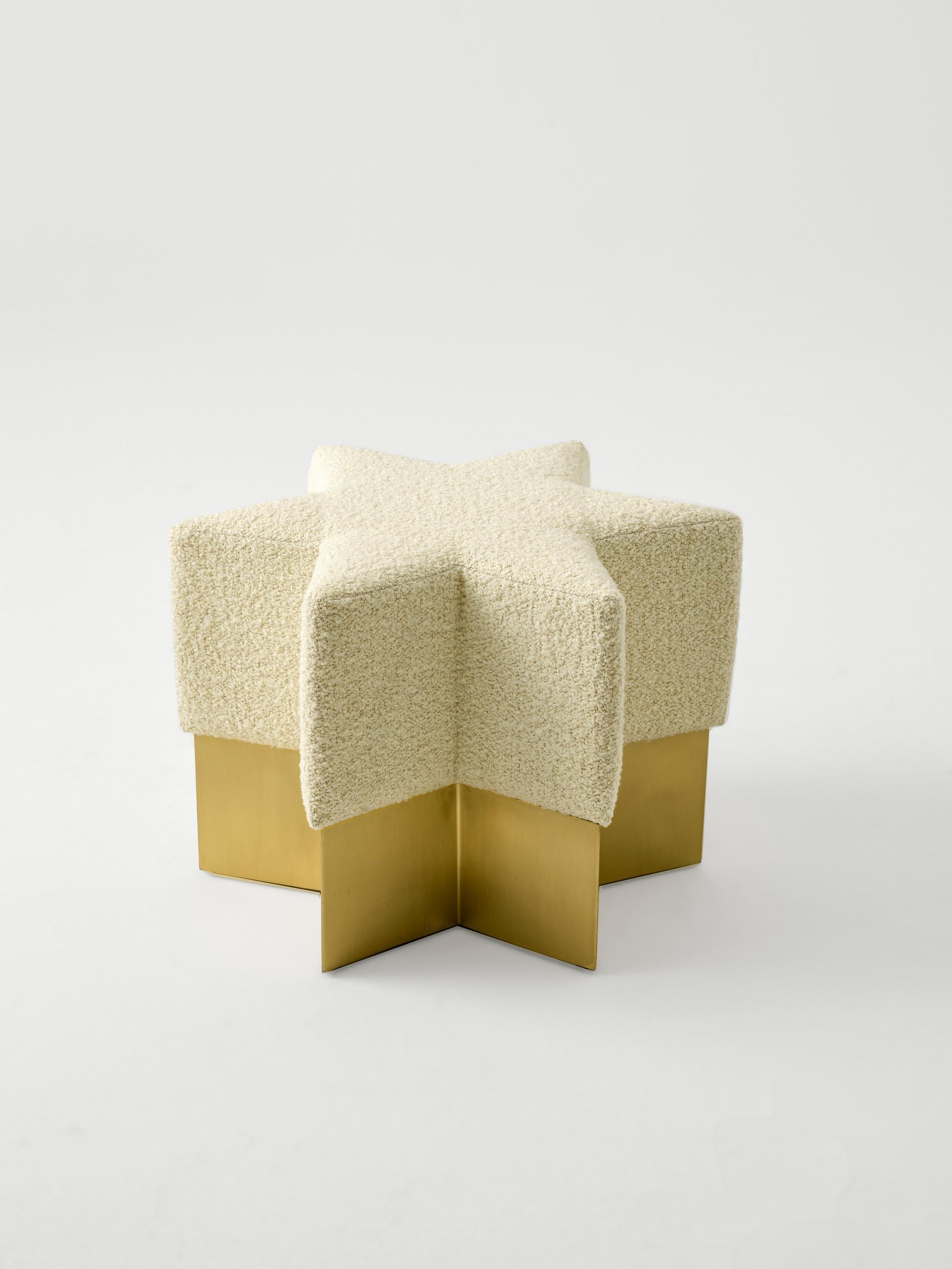 “Starboy Pouf” is inspired by the celestial sphere. It is a metaphorical object from the skies which has been projected to the observer on earth. The cream colored boucle and matte brass base of 