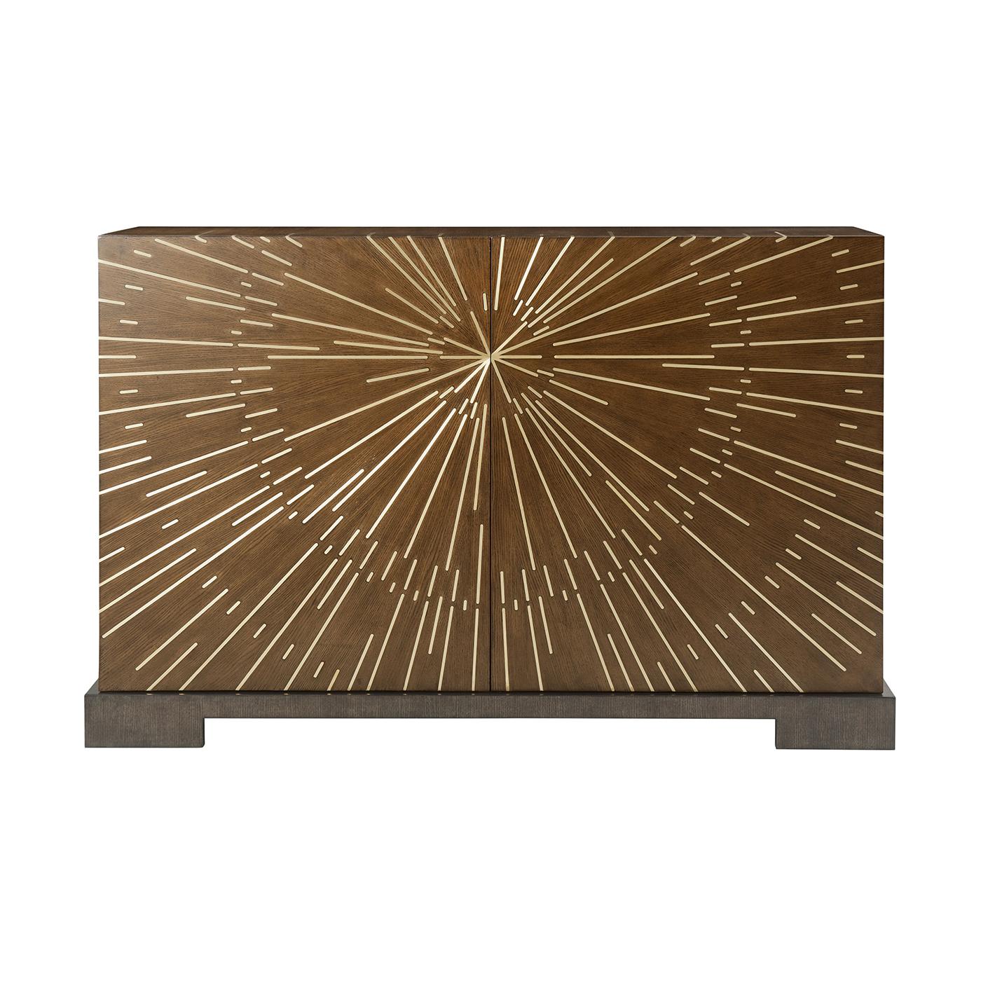 Set upon a robust mahogany base, this two-door cabinet exudes luxury and style. The starburst brass inlay pattern, meticulously designed across the doors and case, is showcased in our elegant Gelato finish, adding a touch of glamour to any