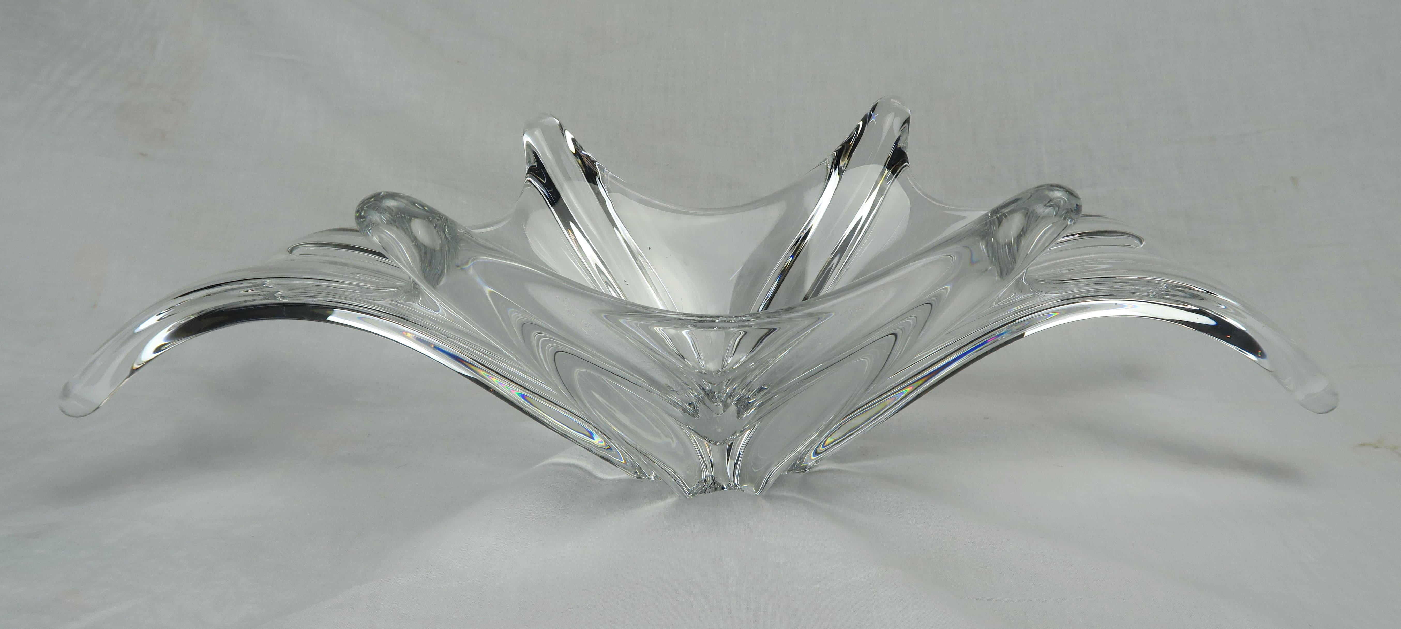 This gorgeous starburst shaped clear glass bowl was made by Baccarat (France) and looks like an organic drop of water, frozen in time. Dramatic, striking and perfect as a centerpiece. Etched makers mark and in excellent condition with minor wear on
