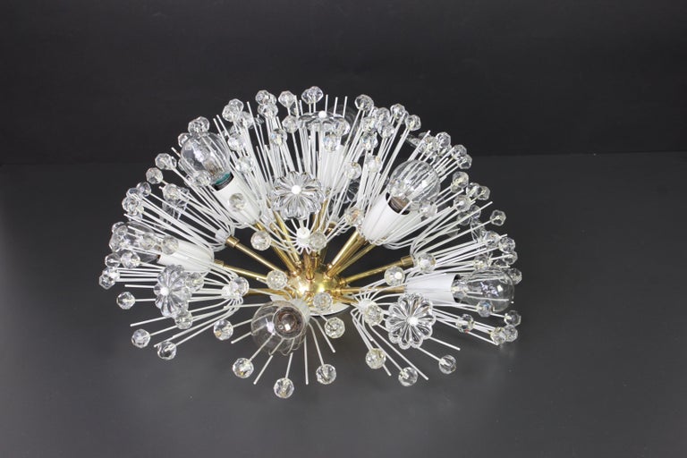 Beautiful large starburst brass flush mount with hundreds of crystals designed by Emil Stejnar for Nikoll, manufactured in Austria, circa 1960s.

Heavy quality and in good condition with small signs of age.
Cleaned, well-wired and ready to use.