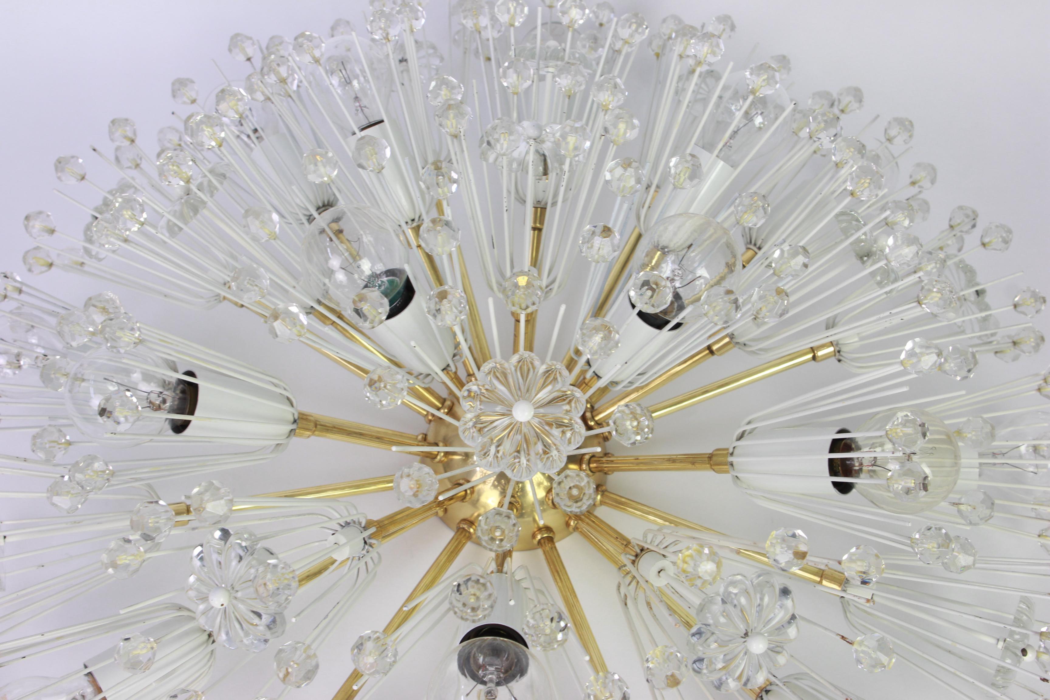 Beautiful large starburst brass flush mount with hundreds of crystals designed by Emil Stejnar for Nikoll, manufactured in Austria, circa 1960s.

Heavy quality and in good condition with small signs of age.
Cleaned, well-wired and ready to use.