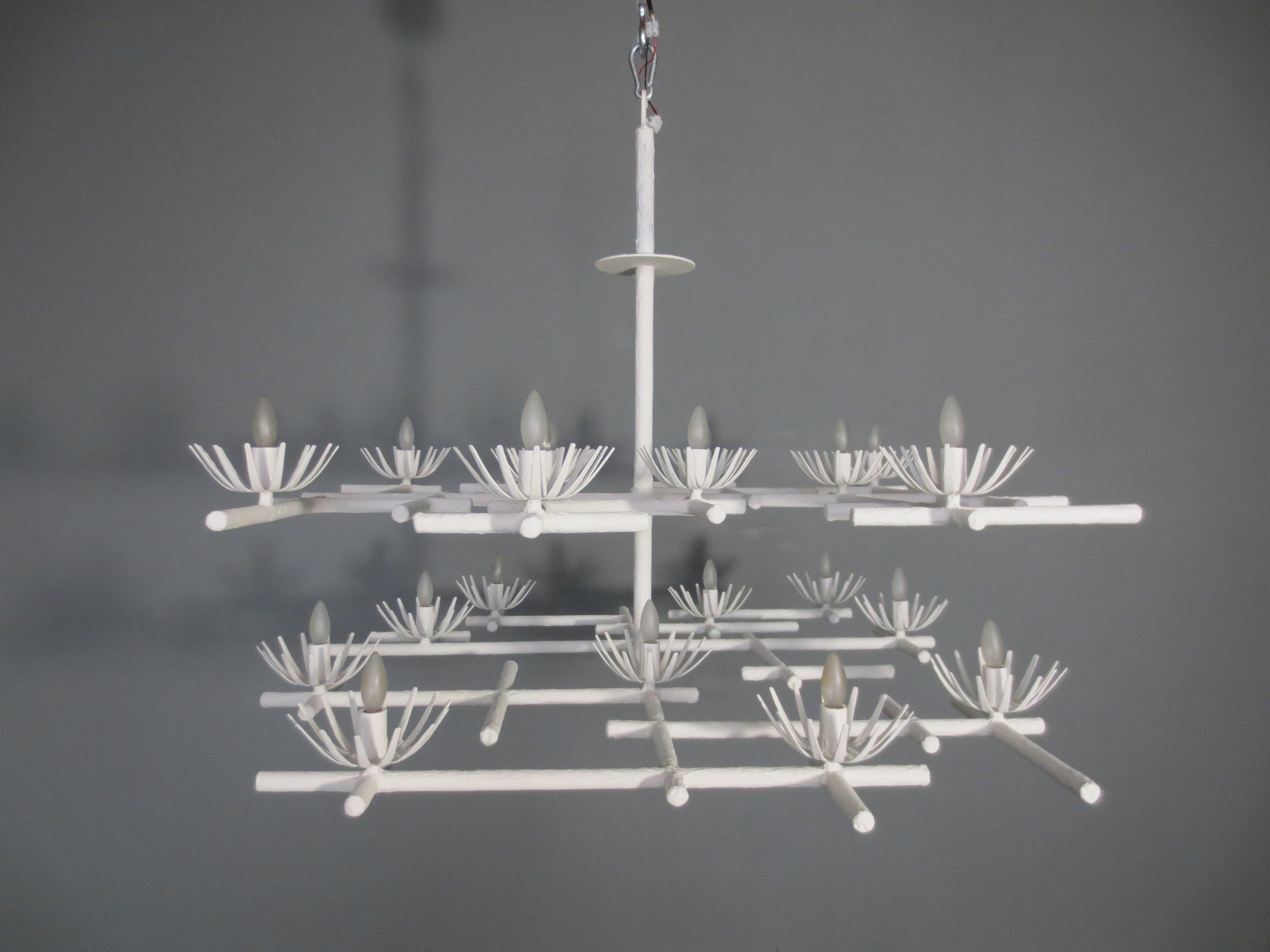 Starburst Chandelier by Tracey Garet of Apsara Interior Design. Multi layered chandelier with 16 candelabra lights coming out of starbursts. The piece shown is in white plaster. . The fabrication is plaster over steel tubing. All Apsara Lighting