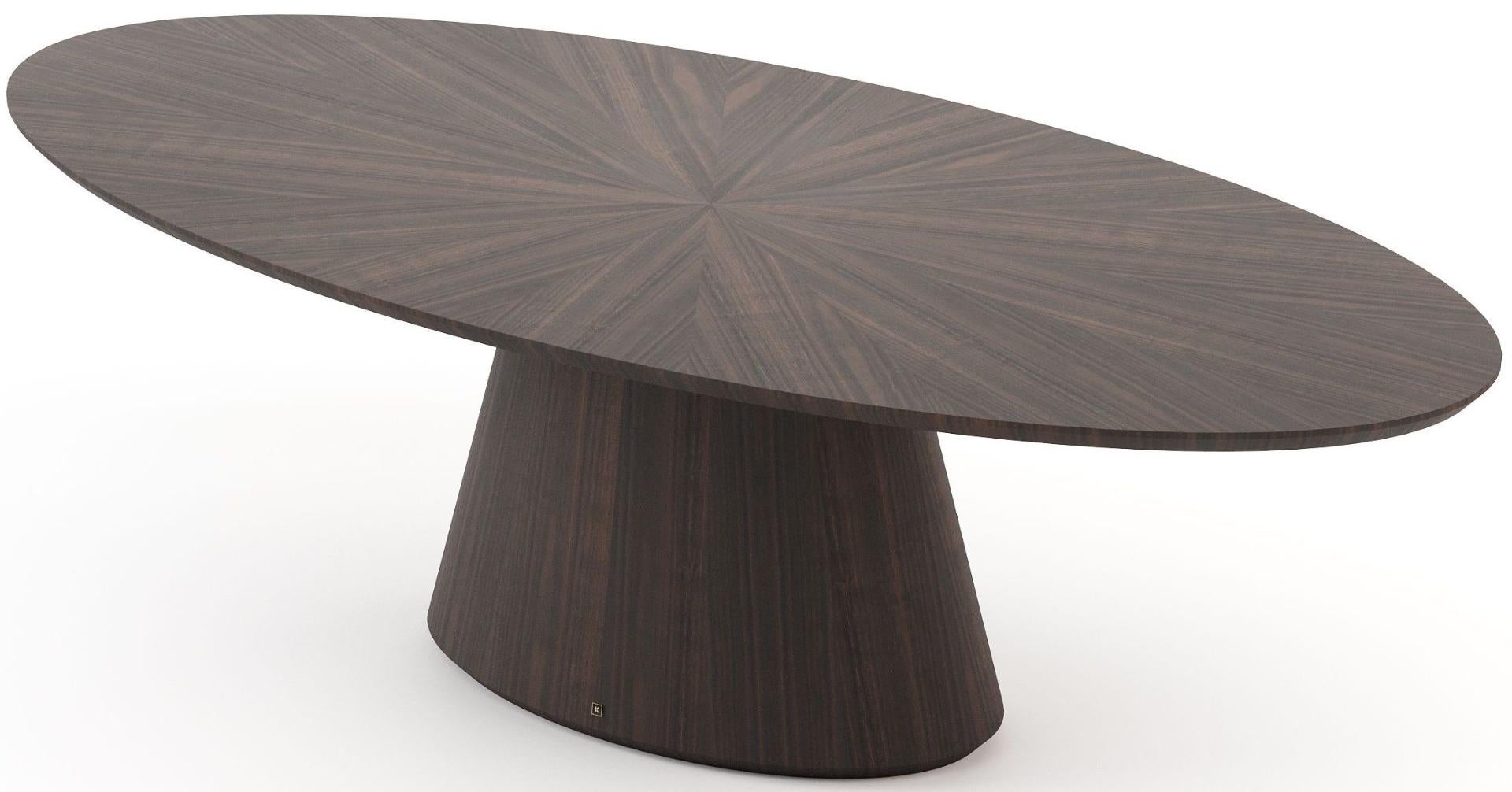 Crafted with an air of opulence and innovation, the dining table stands as a testament to exquisite design tailored for discerning dining spaces. Its oval-shaped top, supported by a sturdy column, harmoniously merges functionality with aesthetic