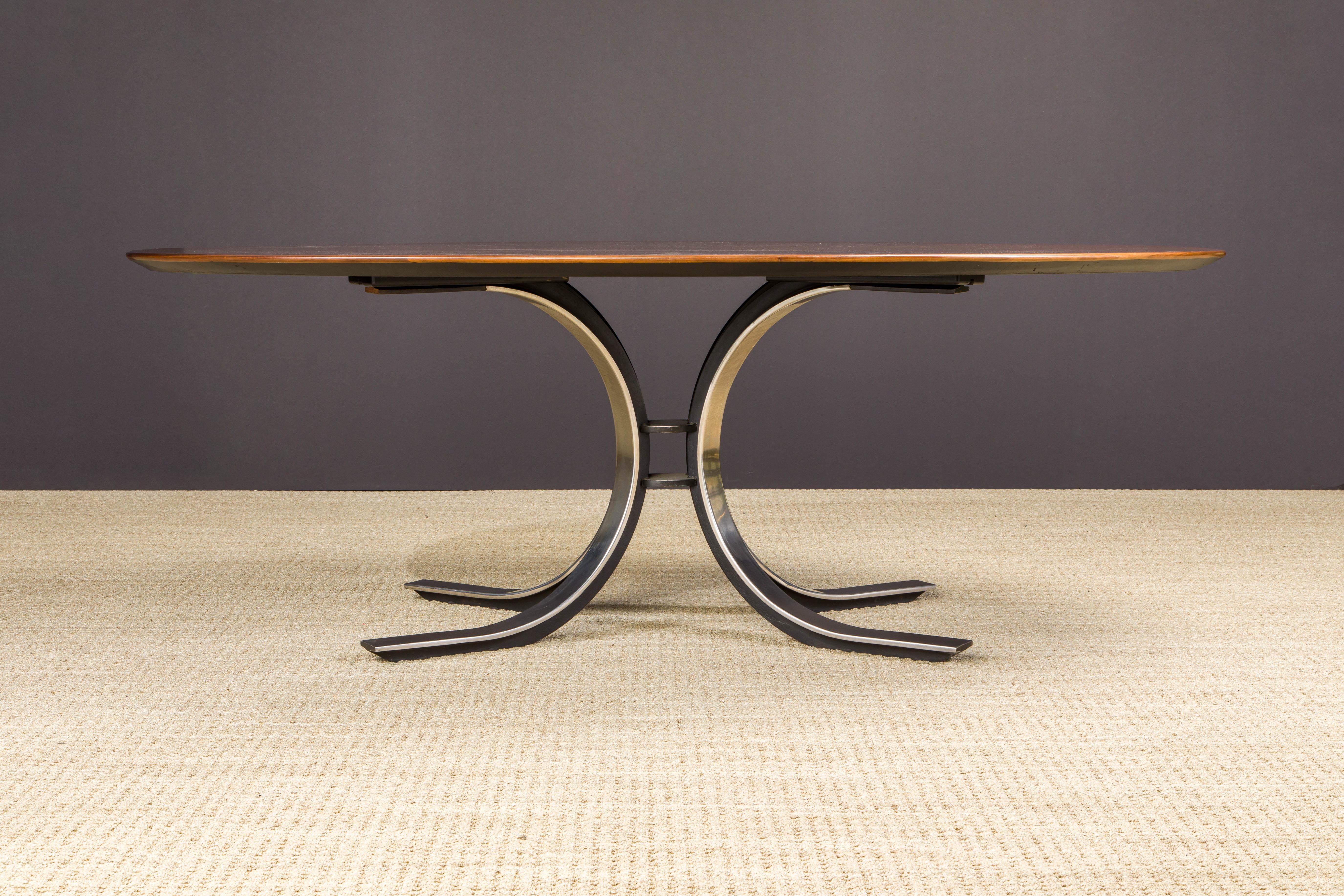 This beautiful dining table by Osvaldo Borsani for Stow Davis, circa 1970, features a beautifully refinished oval top in starburst walnut over a heavy contrasting polished and black enameled steel tulip base. The top was refinished in a French