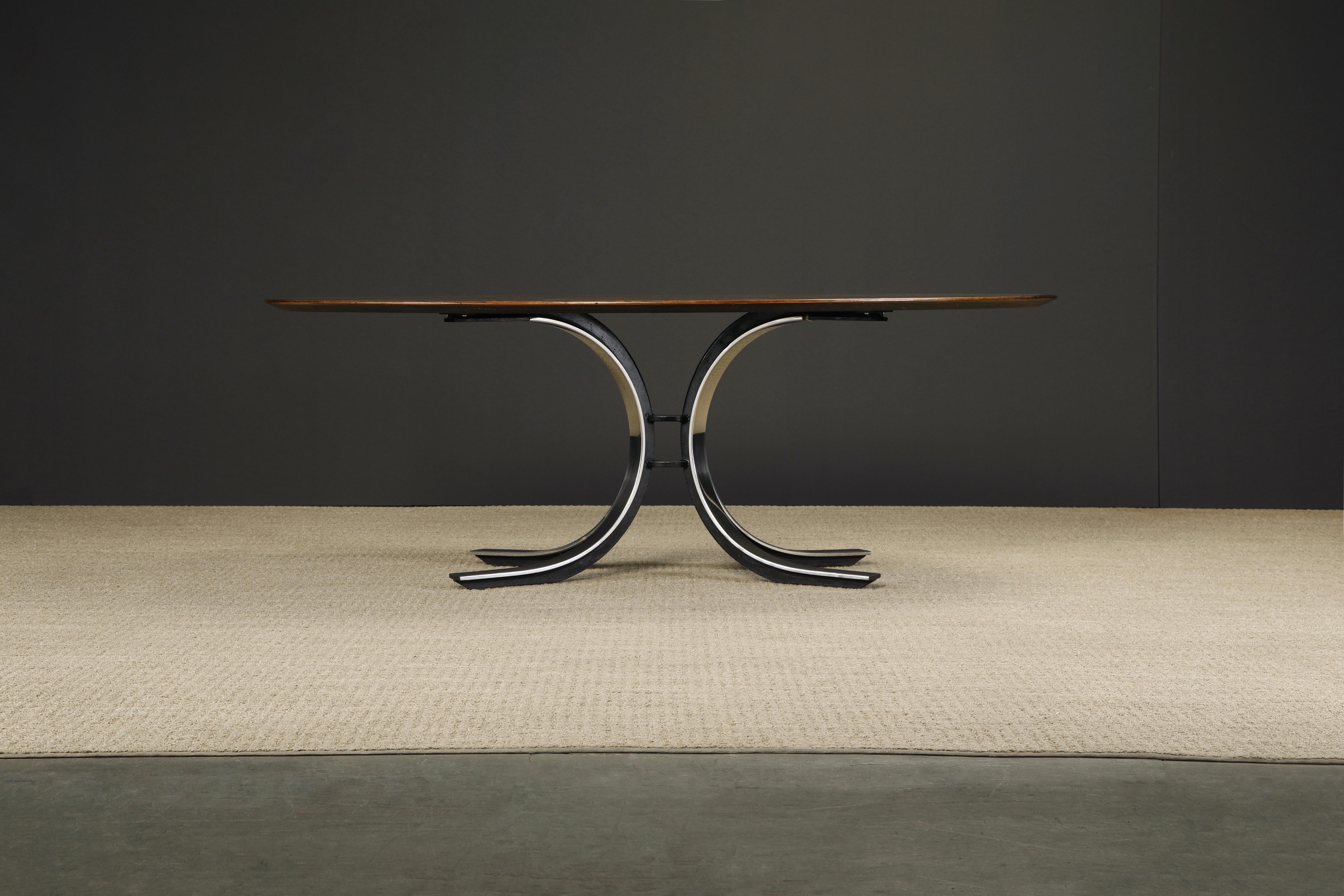 This beautiful dining table by Osvaldo Borsani for Stow Davis, circa 1970, features a beautiful oval top in starburst walnut over a heavy contrasting polished and black enameled steel tulip base. 

Consider using this Stow Davis dining table,