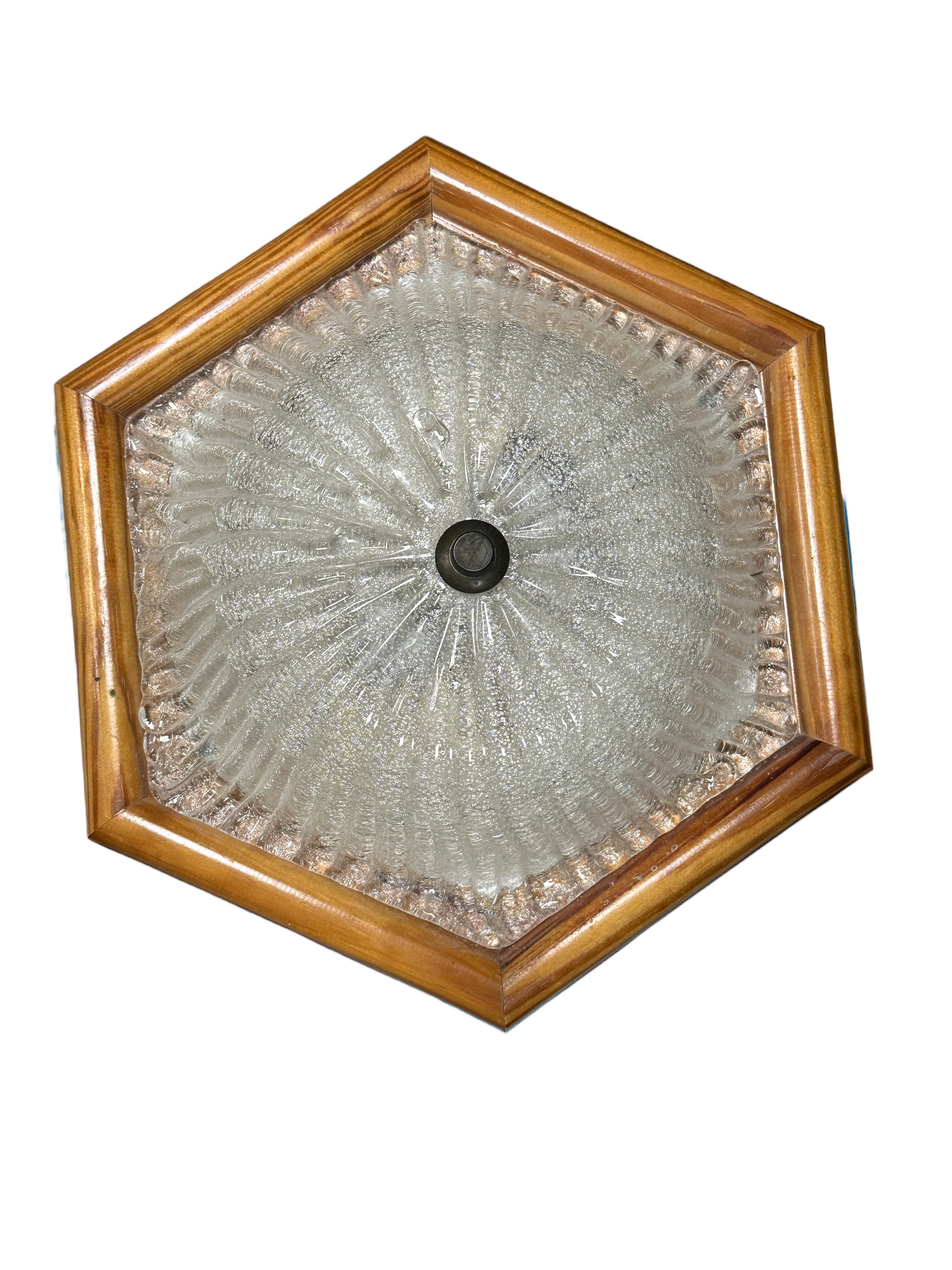 A beautiful ice glass flush mount. Made in Austria by Eglo Leuchten in the 1980s. Gorgeous textured glass flush mount with metal fixture and a wooden frame. The Fixture requires two European E14 / 110 Volt Candelabra bulbs, each bulb up to 40 watts.