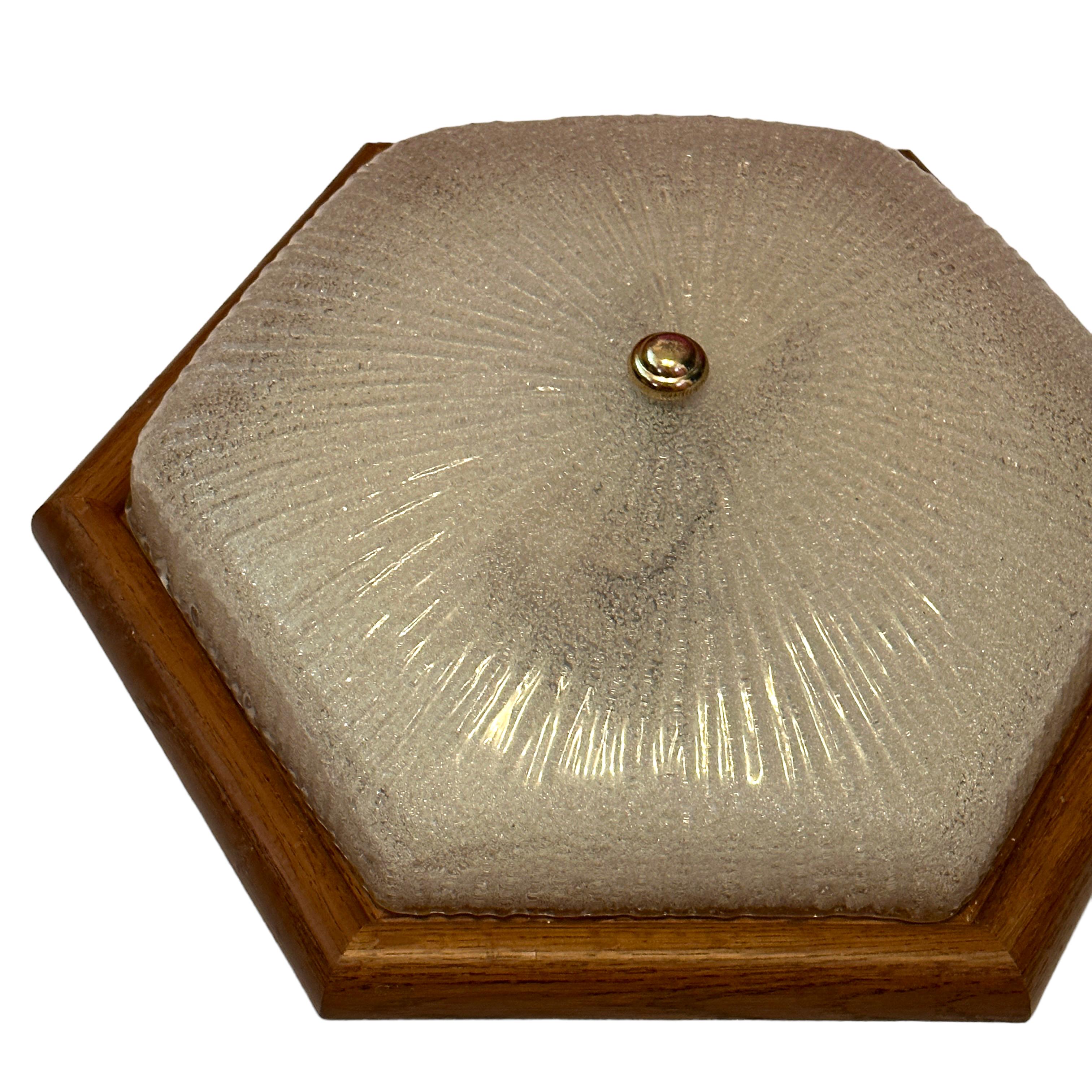 A beautiful ice glass flush mount. Made in Germany in the 1970s. Gorgeous textured glass flush mount with metal fixture and a wooden frame. The Fixture requires two European E27 / 110 Volt Edison bulbs, each bulb up to 60 watts. A nice addition to